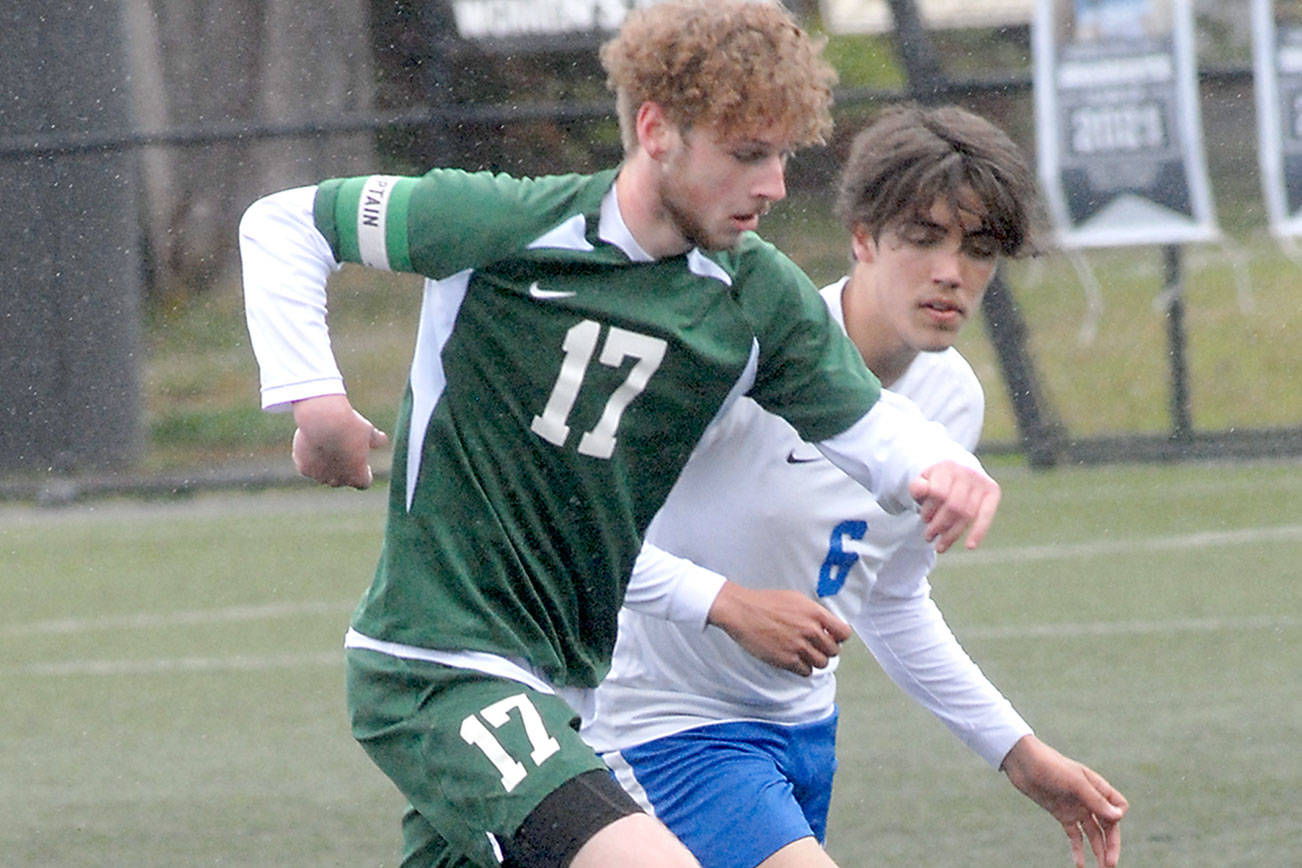 Keith Thorpe/Peninsula Daily News
Port Angeles' Porter Litle, front, races with Bremerton's Jeffery Pickering for the ball on Saturday in Port Angeles.