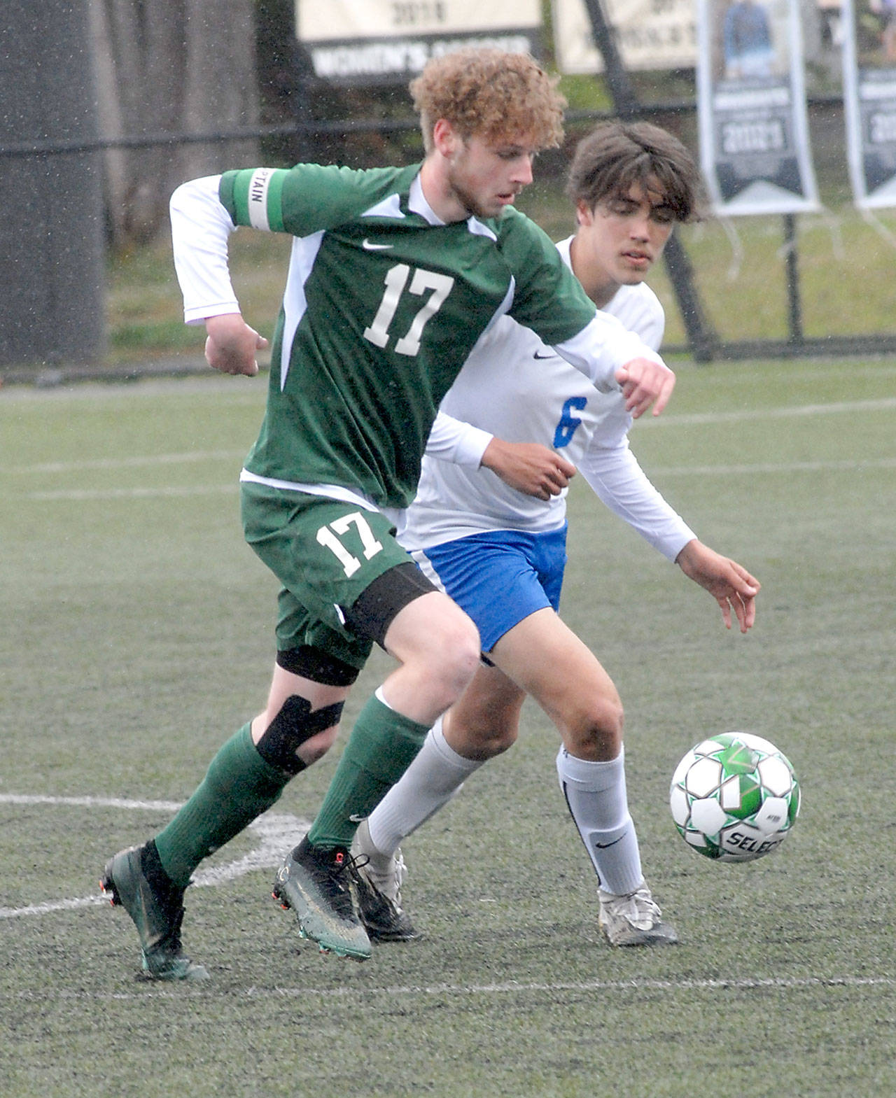 Port Angeles’ Porter Litle, front, races with Bremerton’s Jeffery Pickering for the ball on Saturday in Port Angeles. (Keith Thorpe/Peninsula Daily News)