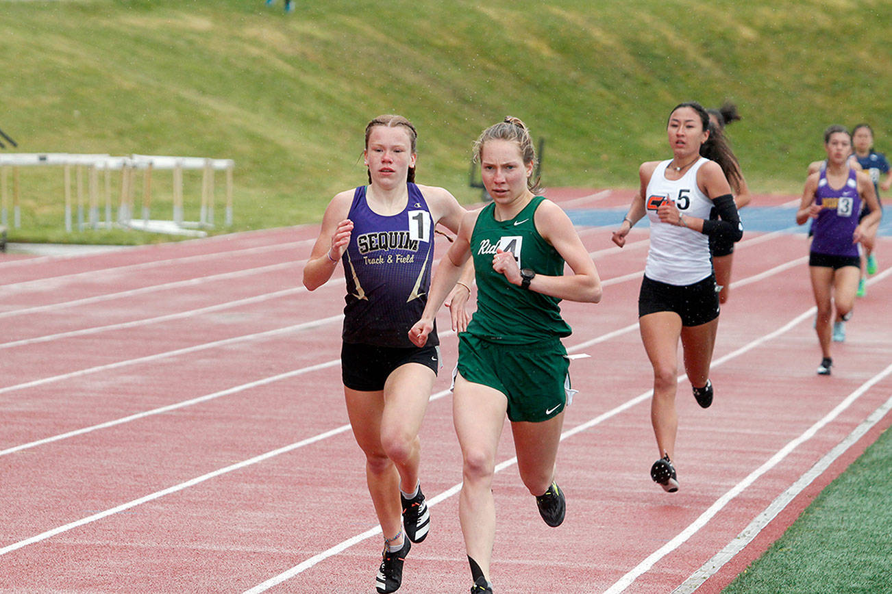 Sequim's Riley Pyeatt and Port Angeles's Lauren Larson go toe-to-toe in the 800. Pyeatt won the race by two seconds, but Larson came back to win the 3,200 as Pyeatt and Larson combined to win the 400, 800, 1,600 and 3,200. (Mark Krulish/Kitsap News Group)