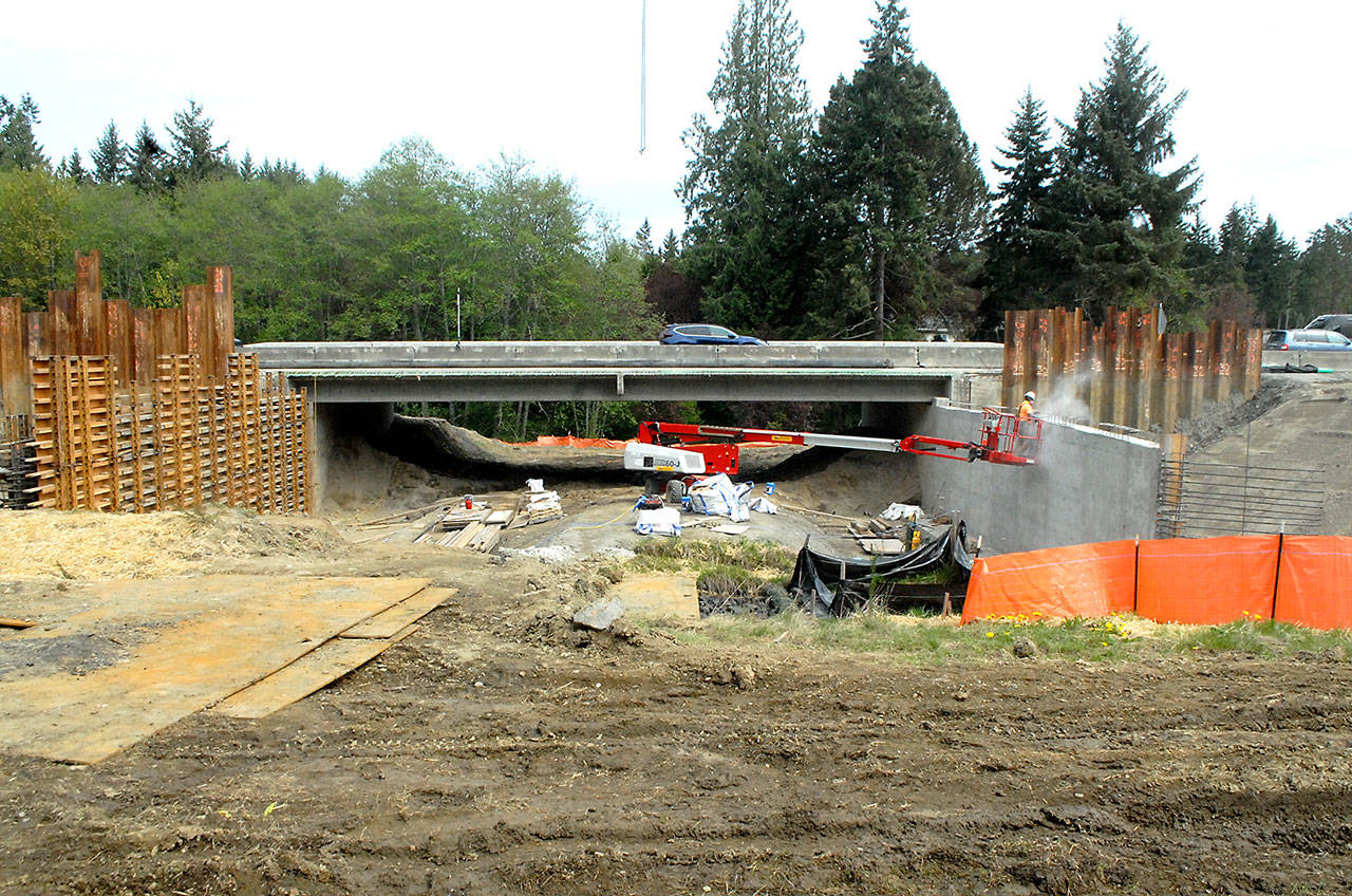 Traffic crosses a new bridge on U.S. Highway 101 over Bagley Creek east of Port Angeles on Wednesday as work continues on building a second bridge for the eastbound lanes. The project, designed to replace aging culverts for improved salmon habitat, also includes a new bridge over Siebert Creek farther east, as well as smaller box culverts on South Bagley Creek Road and James Page Road. The $30.6 million project, which is expected to last until late fall, currently has traffic constricted to a single lane in each direction through the two major construction zones. (Keith Thorpe/Peninsula Daily News)