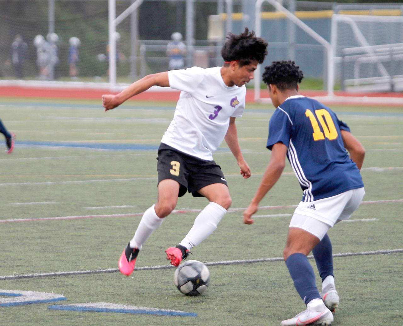 Group Sequims Christian Gonzales looks to dribble past Bainbridges Damoni Mckenna-Greenawalt during the Olympic League Boys Soccer Championship. (Mark Krulish/Kitsap News Group)