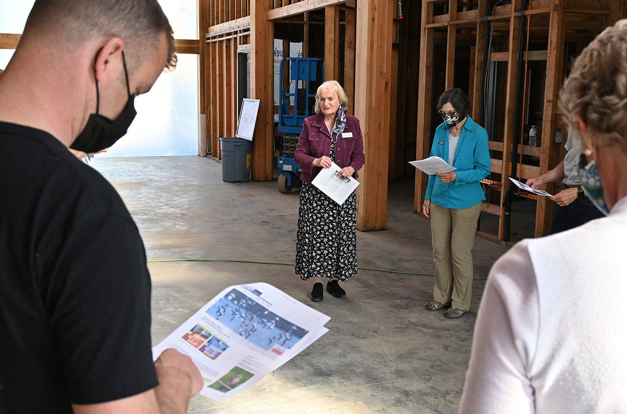 Annette Hanson, chair of the Inspire Wonder Capital Campaign helping fund the major renovation at the Dungeness River Audubon Center, shows Sequim Sunrise Rotary Foundation board members where bird-safe windows will be installed. The club last week donated $250,000 to the project. (Michael Dashiell/Olympic Peninsula News Group)