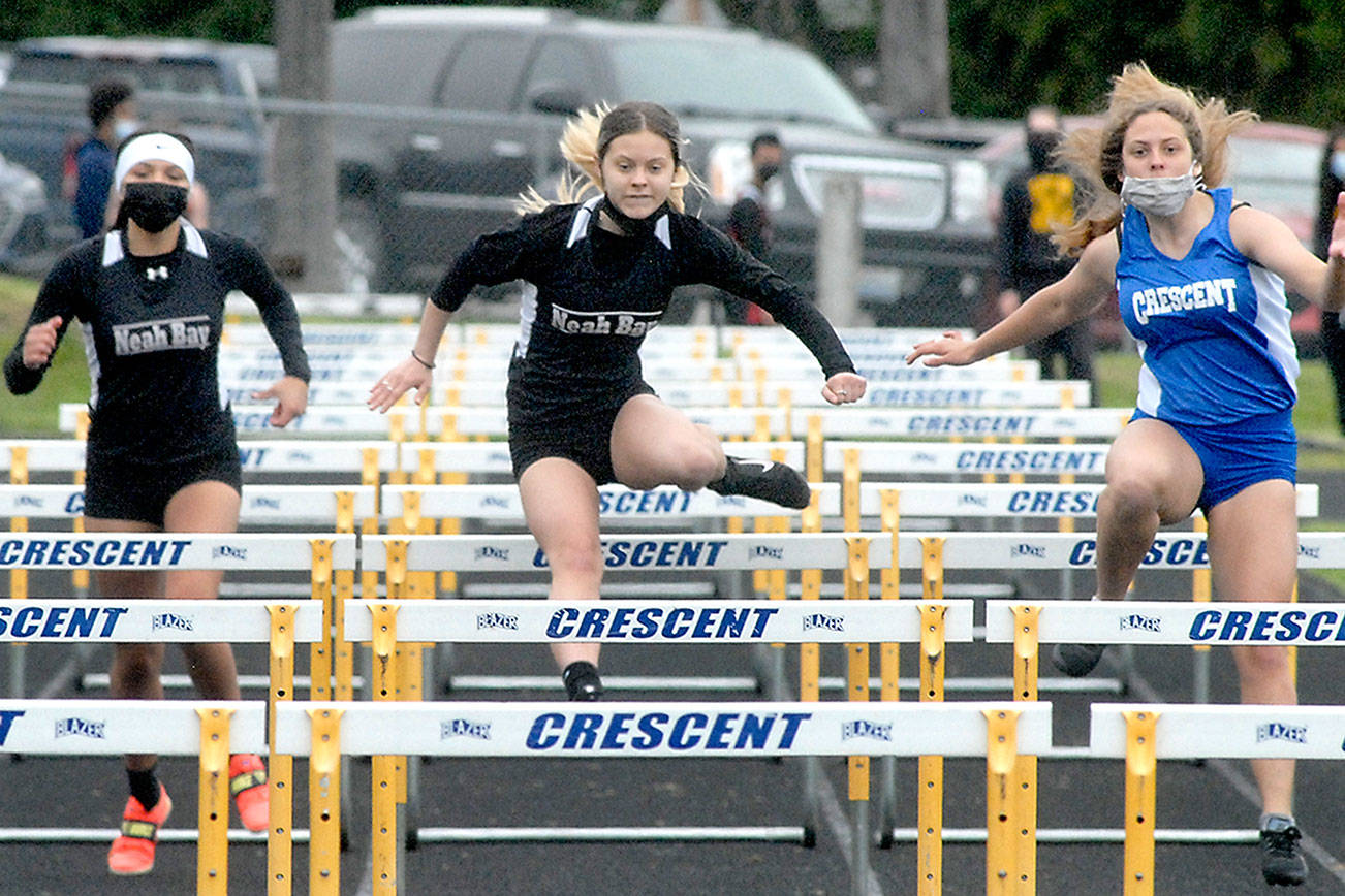 Keith Thorpe/Peninsula Daily News
Neah Bay's Ruth Greene, left, and Kianah Cameron, and Crescent's JoCy Kazlauskas  reace in the 100-meter hurdles on Friday.