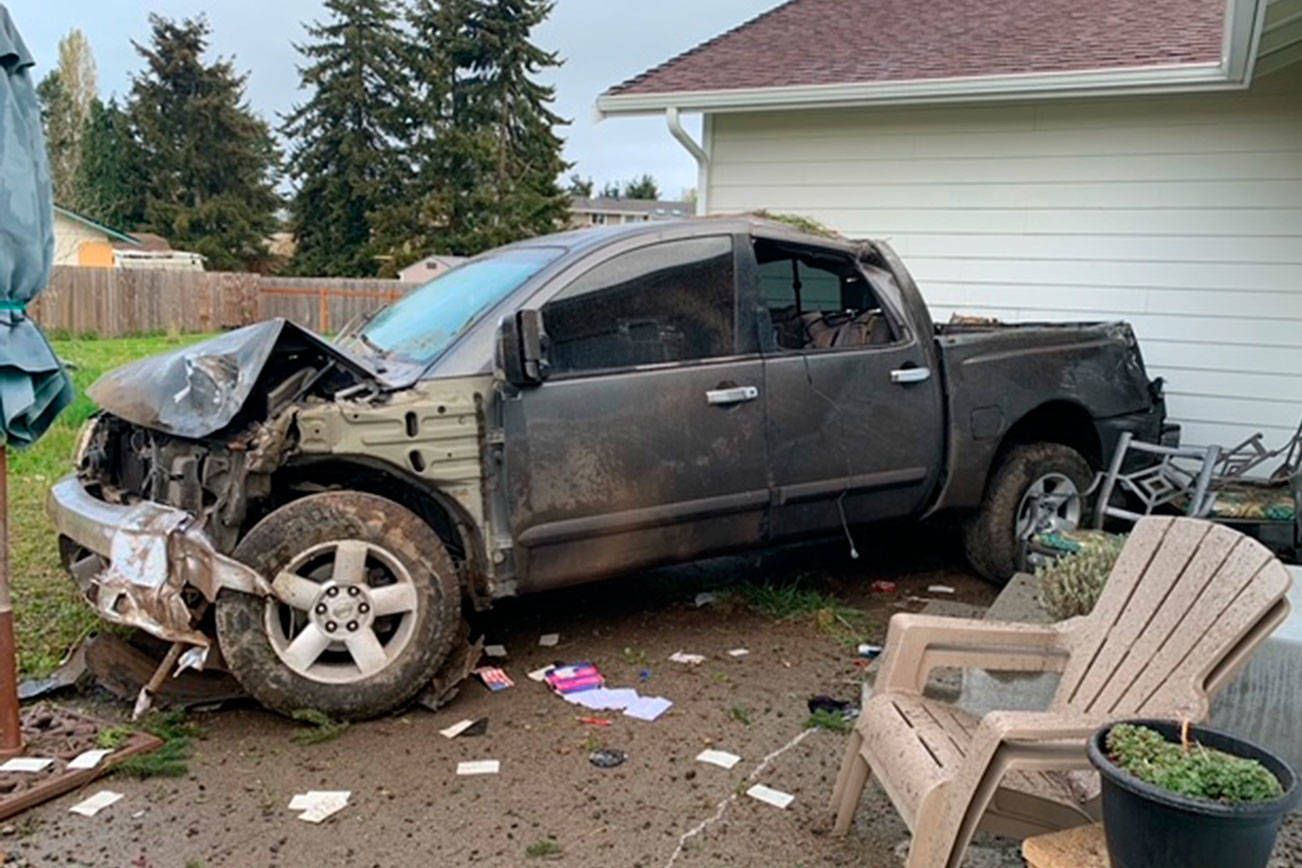 A pickup struck a house after hitting a tree off Woodcock Road in Sequim. Photo courtesy of Clallam County Sheriff’s Office