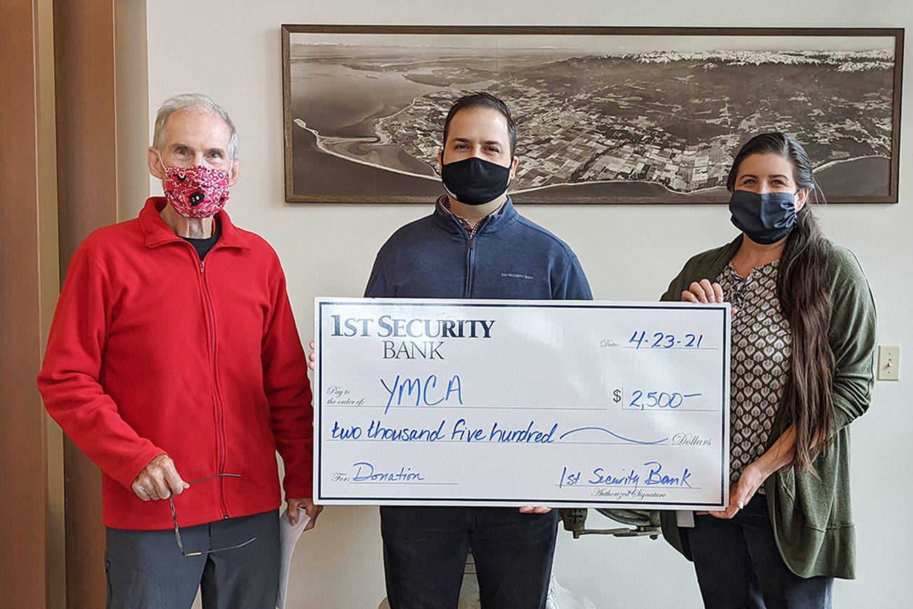Gary Huff, left, board director and campaign chairman for the Olympic Peninsula YMCA’s 2021 Impact Campaign, accepts a donation for the YMCA from 1st Security Bank, represented by Vice President Branch Manager Anthony Aceto and 1st Security personal banker Sheena Zahn.(Photo courtesy of Olympic Peninsula YMCA)