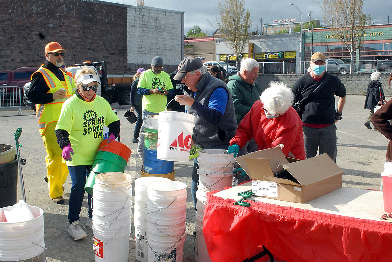 Participants in Saturday’s “Big Spring Spruce Up” pick up empty buckets for weeds and other organic waste before fanning out over downtown Port Angeles in an effort to clean up the city. (Keith Thorpe/Peninsula Daily News)