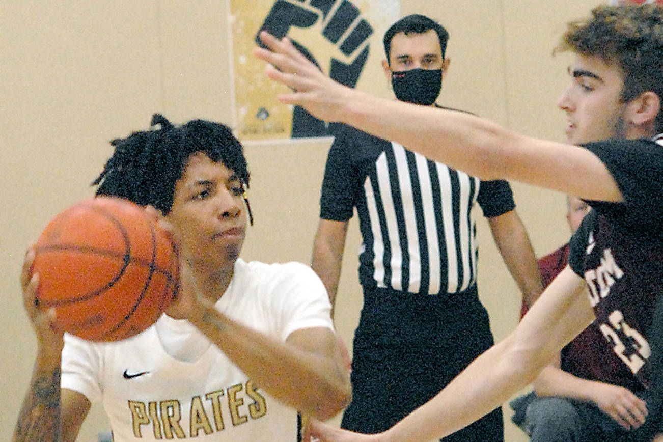 Keith Thorpe/Peninsula Daily News
Peninsula's Mikey Madlock, left, looks for a way to the hoop around Whatcom's Jackson Short, right during Friday's game at Peninsula College in Port Angeles.