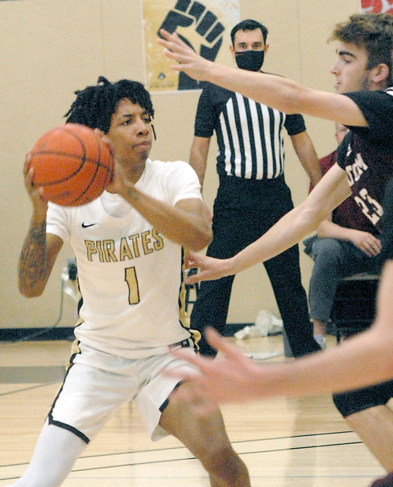 Peninsulas Mikey Madlock, left, looks for a way to the hoop around Whatcoms Jackson Short, right, during Fridays game at Peninsula College in Port Angeles. (Keith Thorpe/Peninsula Daily News)