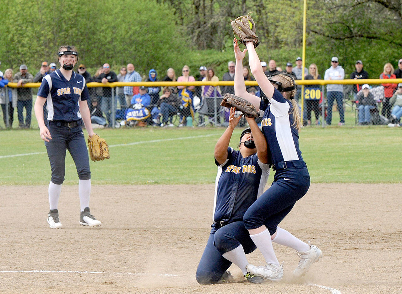 Spartan second baseman Kadie Wood makes the catch of an Adna fly ball for the out over shortstop Elizabeth Soto. Forks placed second in district after falling to Adna 4-3 in extras innings. (Lonnie Archibland/for Peninsula Daily News)
