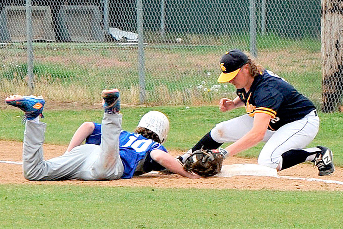 A Toutle Lake baserunner just makes it back to first as Forks' Tyler Wood makes the tag after taking a pick off throw from pitcher Carter Windle at WF West High School in Chehalis Saturday. Forks placed second in district after dropping this contest 2-1 to the Ducks. (Lonnie Archibald/for Peninsula Daily News)