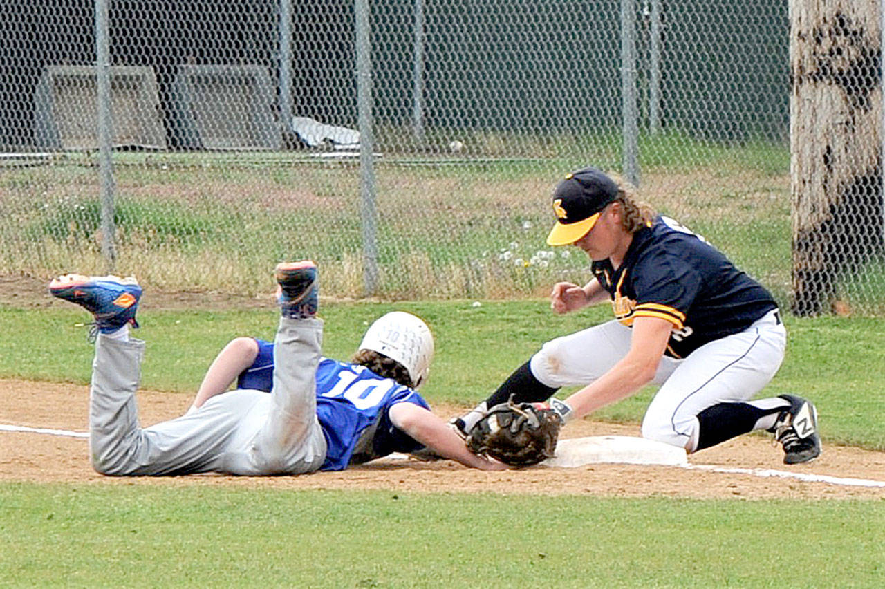 A Toutle Lake baserunner just makes it back to first as Forks’ Tyler Wood makes the tag after taking a pick off throw from pitcher Carter Windle at WF West High School in Chehalis Saturday. Forks placed second in district after dropping this contest 2-1 to the Ducks. (Lonnie Archibald/for Peninsula Daily News)