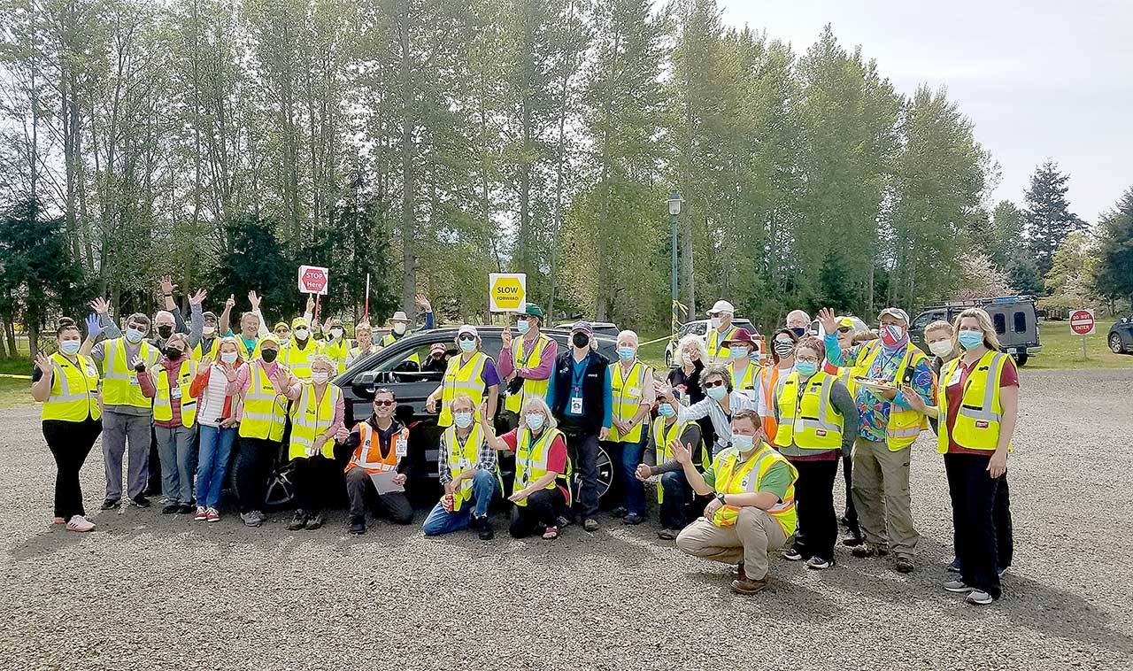 Jamestown Family Clinic workers and Community Emergency Response Team volunteers celebrate the final day of the mass vaccination drive-thru clinic Thursday at Carrie Blake Community Park in Sequim.