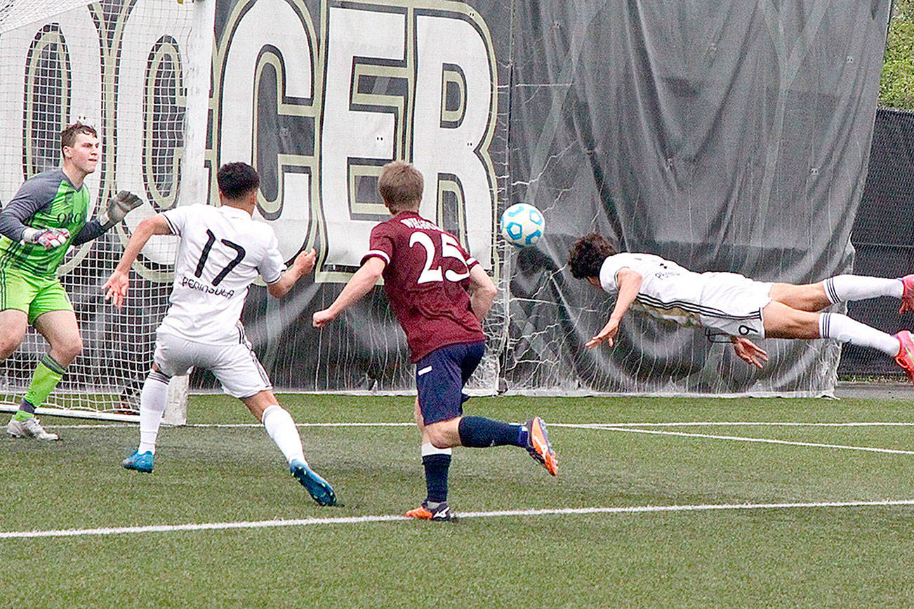 Dave Logan/for Peninsula Daily News
Peninsula College's Nico Hernandez heads in a goal against Whatcom on Monday afternoon. In on the play is Peninsula's Fernando Tavares (17).