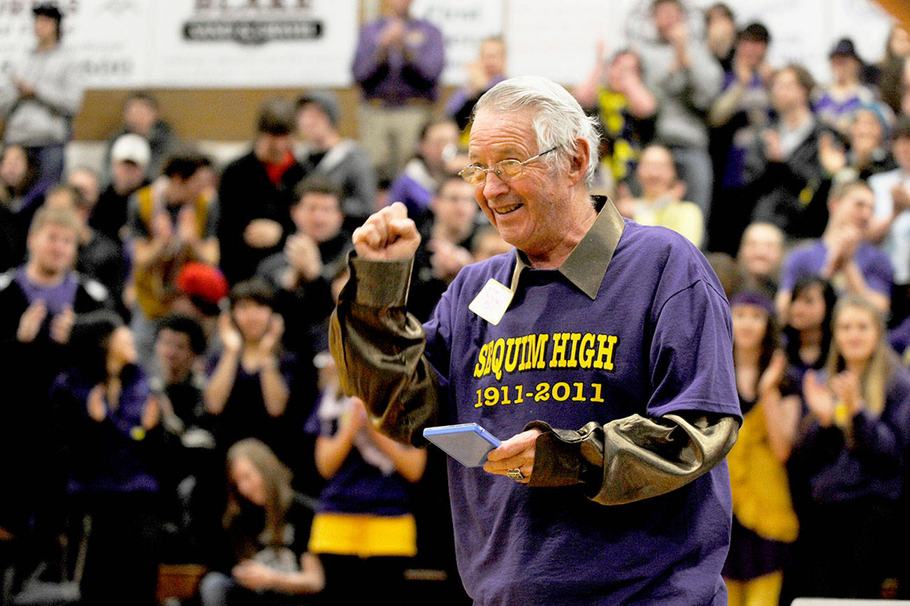 Myron Teterud, a longtime Sequim schools and community supporter, gives the crowd a salute after being honored as “Fan of the Century” at Sequim High School’s centennial celebration in January 2011. Friends and acquaintances are mourning Teterud’s death on April 29. (Michael Dashiell/Olympic Peninsula News Group)