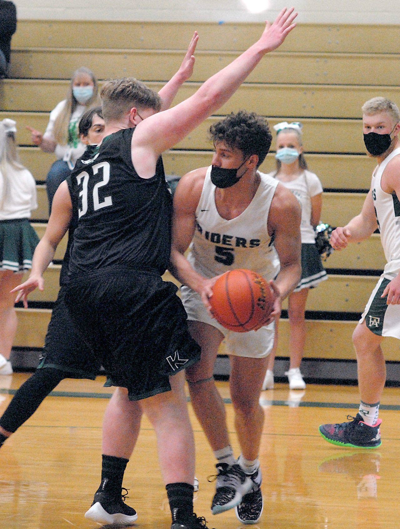 Keith Thorpe/Peninsula Daily News Port Angeles’ Chase Cobb, center, looks for a way around the defense of Klahowya’s Cannon Leifeste, left, as Cobb’s teammate, Adam Watkins, right, looks on during Thursday’s game at Port Angeles High School.