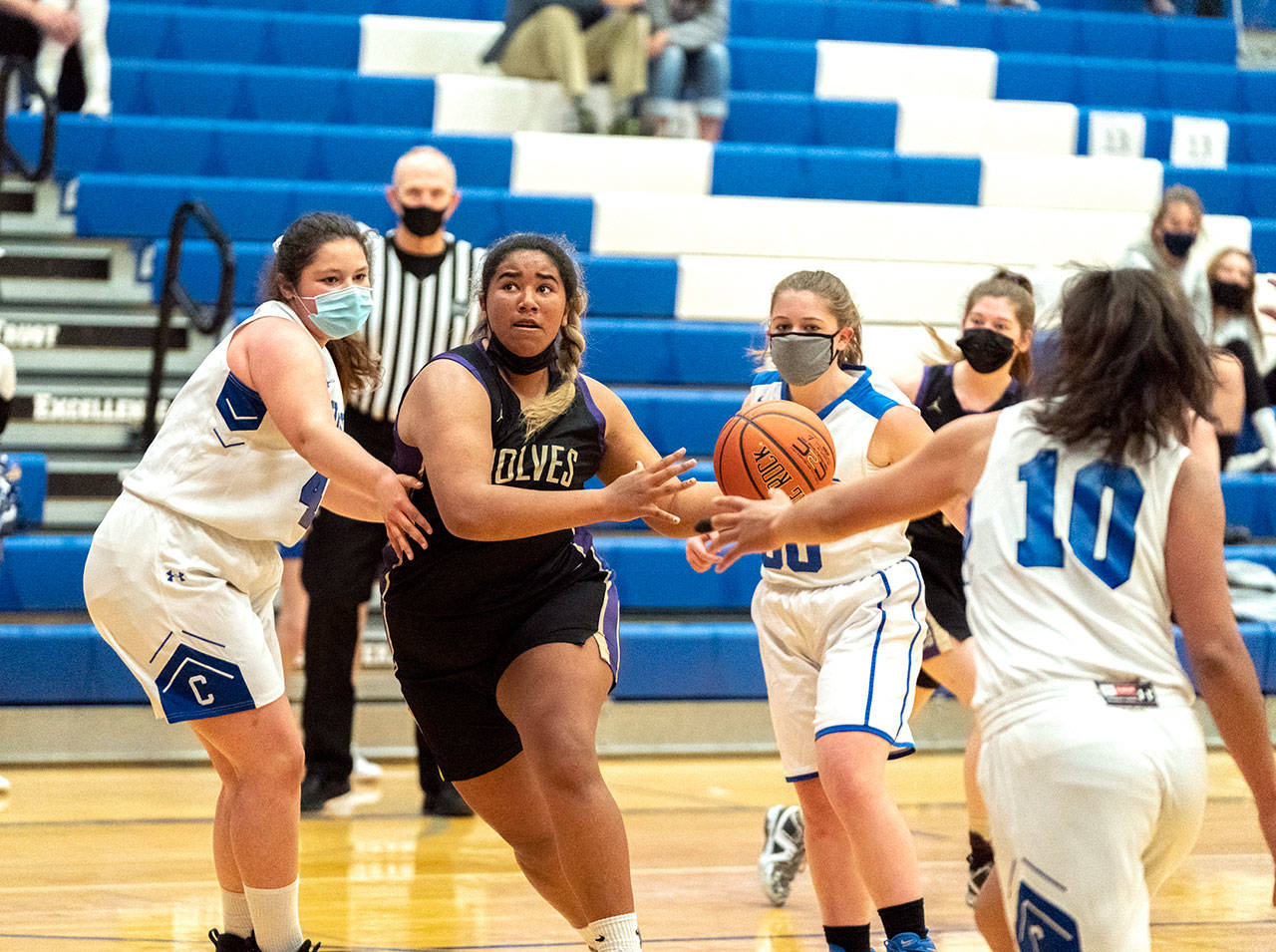 Sequims Jelissa Julmist keeps her eyes on the basket as she drives for a score against East Jeffersons Alyssa Vandenberg, left, Shelby Theibelt (30) and Gina Brown during a Saturday game played in Chimacum. (Steve Mullensky/for Peninsula Daily News)