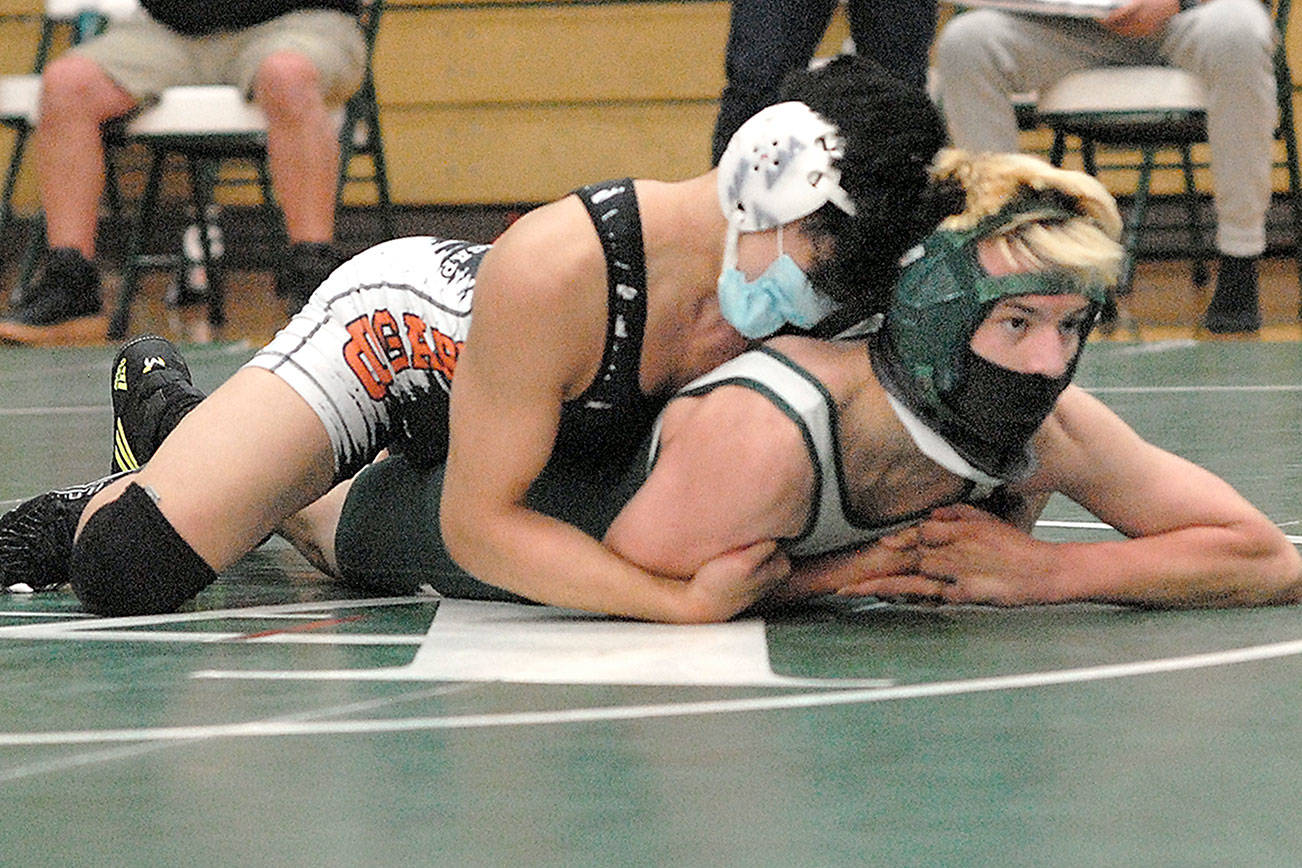 Keith Thorpe/Peninsula Daily News
Port Angeles' Jack Harrelson, front, takes on Central Kitsaps Shayne Hew-Len during Saturday's four-wat meet at Port Angeles High School.