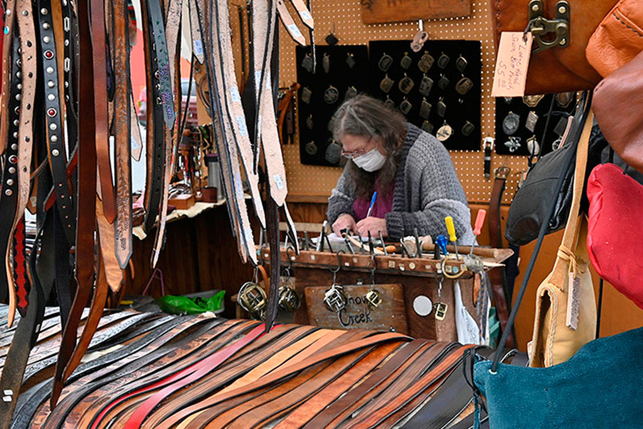 Jenny Preston of Chimacum's Snow Creek Leather works on a belt at the Sequim Irrigation Festival's Innovative Arts and Crafts Fair in downtown Sequim pn Saturday. "I've been coming to this festival since as long as I can remember, possibly the 1970s," Preston said. With health restrictions in place the festival moved all but two events — the fair and the Grand Parade-turned-procession — to virtual presentations. See irrigationfestival.com. Michael Dashiell/Olympic Peninsula News Group