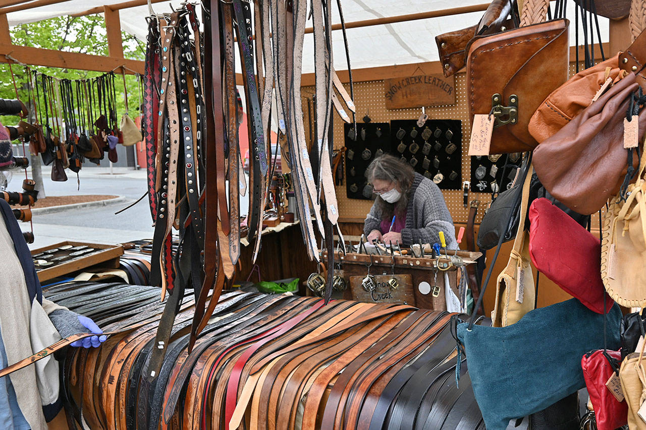 Jenny Preston of Chimacum’s Snow Creek Leather works on a belt at the Sequim Irrigation Festival’s Innovative Arts and Crafts Fair in downtown Sequim Saturday, May 8. “I’ve been coming to this festival since as long as I can remember, possibly the 1970s,” Preston said. With health restrictions in place the festival moved all but two events — the fair and the Grand Parade-turned-procession — to virtual presentations. See irrigationfestival.com. Sequim Gazette photo by Michael Dashiell
Jenny Preston of Chimacum’s Snow Creek Leather works on a belt at the Sequim Irrigation Festival’s Innovative Arts and Crafts Fair in downtown Sequim pn Saturday. “I’ve been coming to this festival since as long as I can remember, possibly the 1970s,” Preston said. With health restrictions in place the festival moved all but two events — the fair and the Grand Parade-turned-procession — to virtual presentations. See irrigationfestival.com. (Michael Dashiell/Olympic Peninsula News Group)