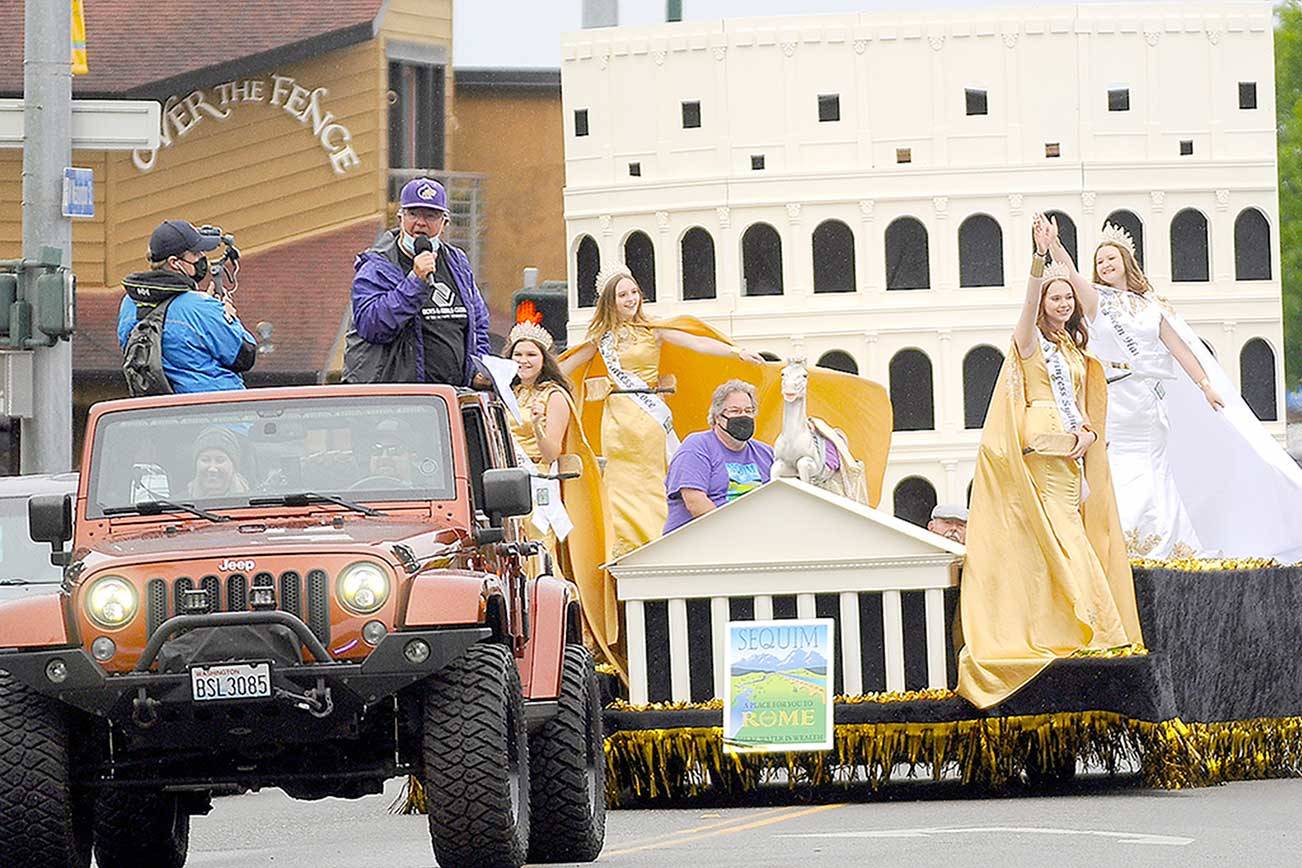 With master of ceremonies Stephen Rosales serving as virtual guide, the 2021 Sequim Irrigation Festival Grand Parade-turned-Procession makes its way through downtown Sequim late Saturday afternoon. Festival royalty includes, from left, princesses Allie Gale and Zoee Kuperus, float builder Guy Horton, princess Sydney VanProyen and queen Hannah Hampton. (Michael Dashiell/Olympic Peninsula News Group)