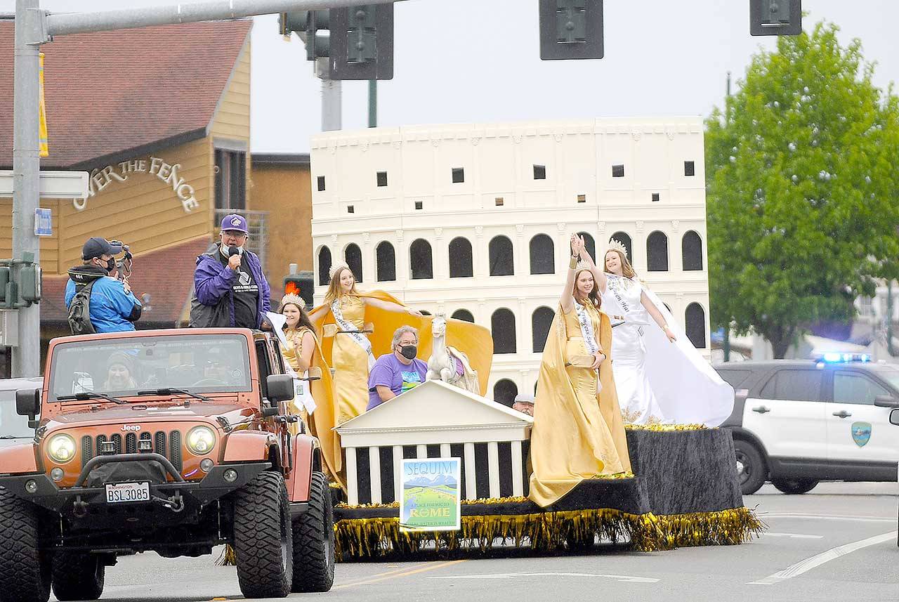With master of ceremonies Stephen Rosales serving as virtual guide, the 2021 Sequim Irrigation Festival Grand Parade-turned-Procession makes its way through downtown Sequim late Saturday afternoon. Festival royalty includes, from left, princesses Allie Gale and Zoee Kuperus, float builder Guy Horton, princess Sydney VanProyen and queen Hannah Hampton. (Michael Dashiell/Olympic Peninsula News Group)