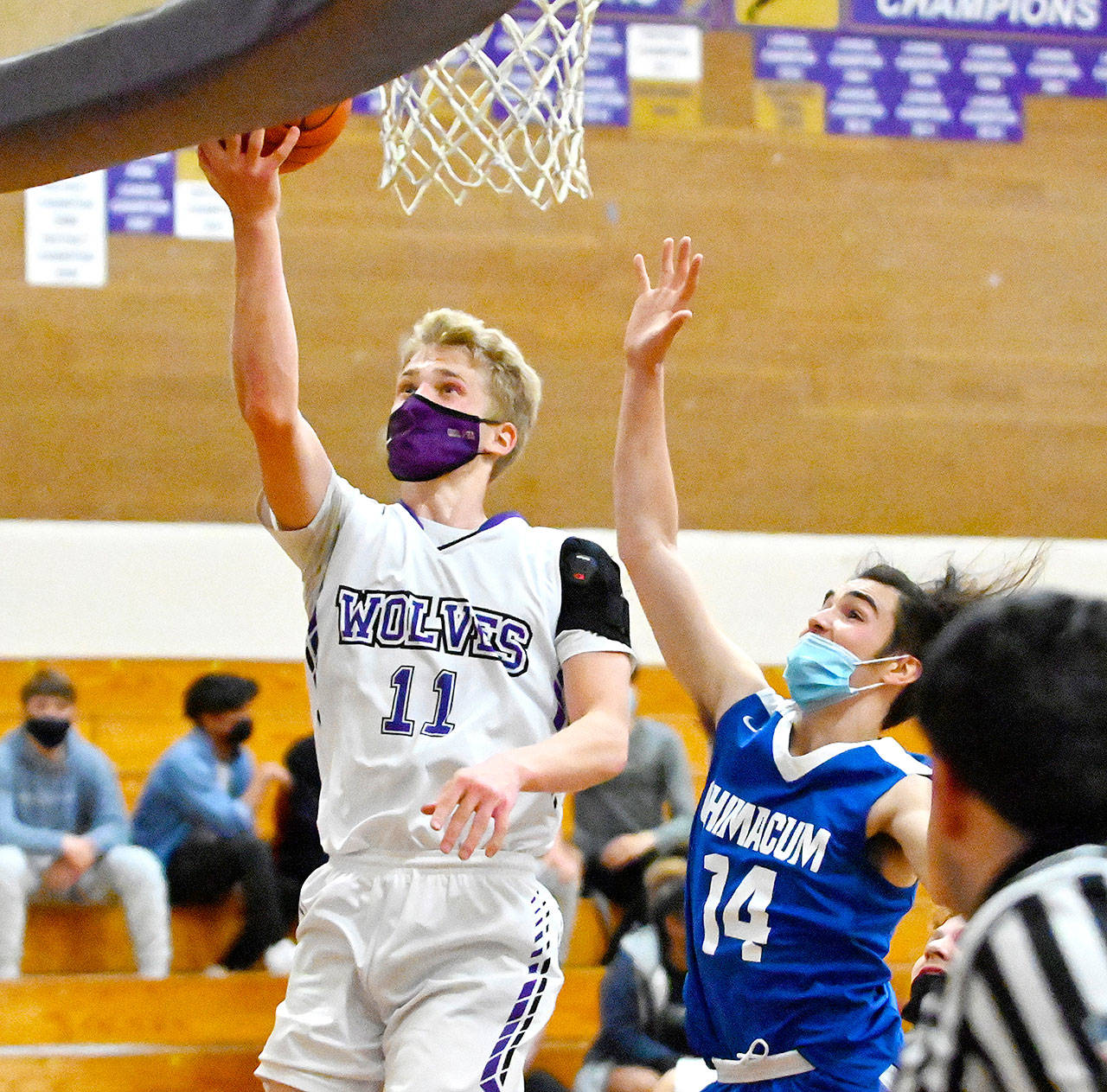 Sequims Erik Christiansen goes up for a layup past East Jeffersons Lonnie Kenney in Monday nights game in Sequim. (Michael Dashiell/Olympic Peninsula News Group)