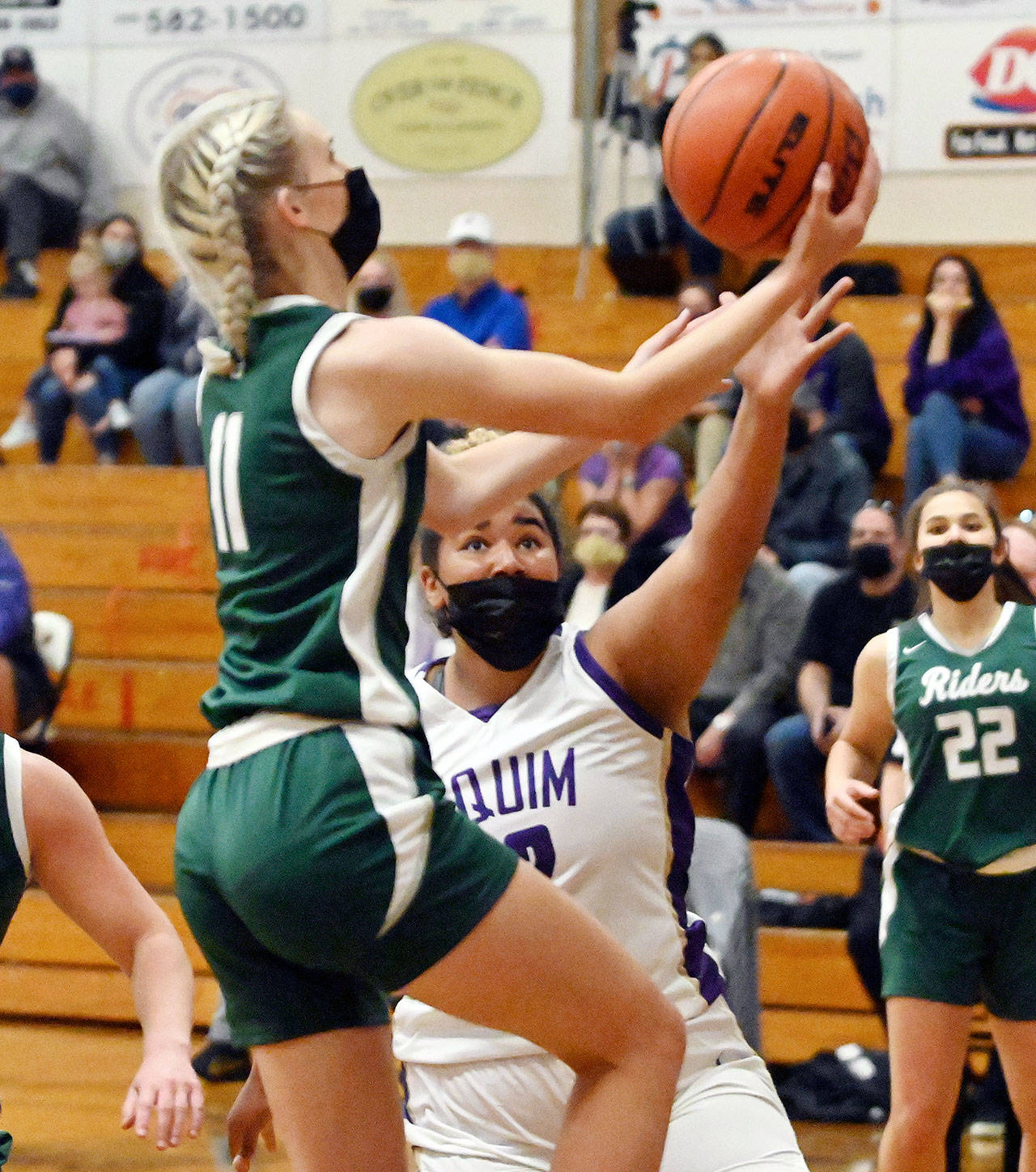 Port Angeles’ Millie Long goes up for a layup while defended by Sequim’s Jelissa Julmist during the Roughriders’ 67-58 win over the Wolves on Wednesday. (Michael Dashiell/Olympic Peninsula News Group)