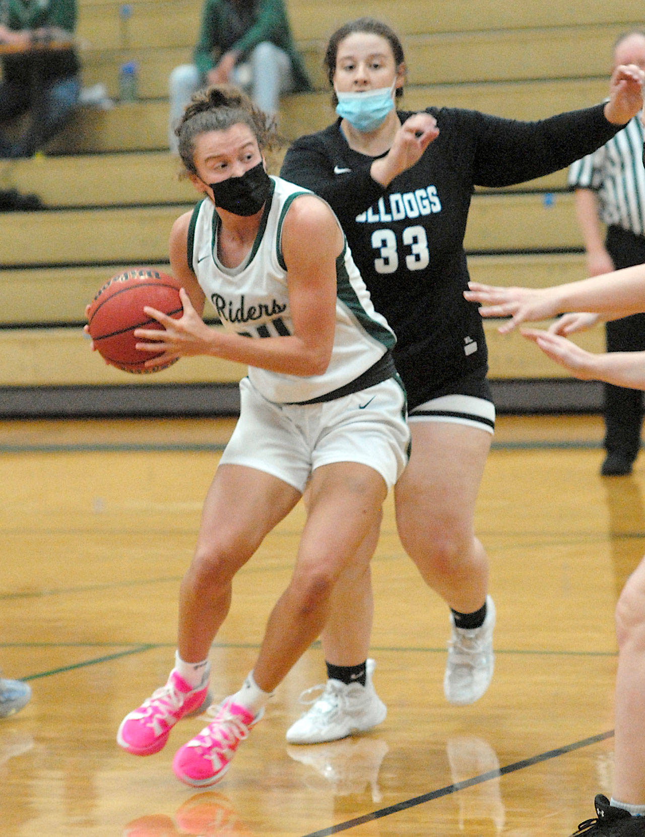 Keith Thorpe/Peninsula Daily News Port Angeles’ Jaida Wood, front, makes her way around North Mason’s Mandy Cole in the first quarter of Friday night’s game in Port Angeles.