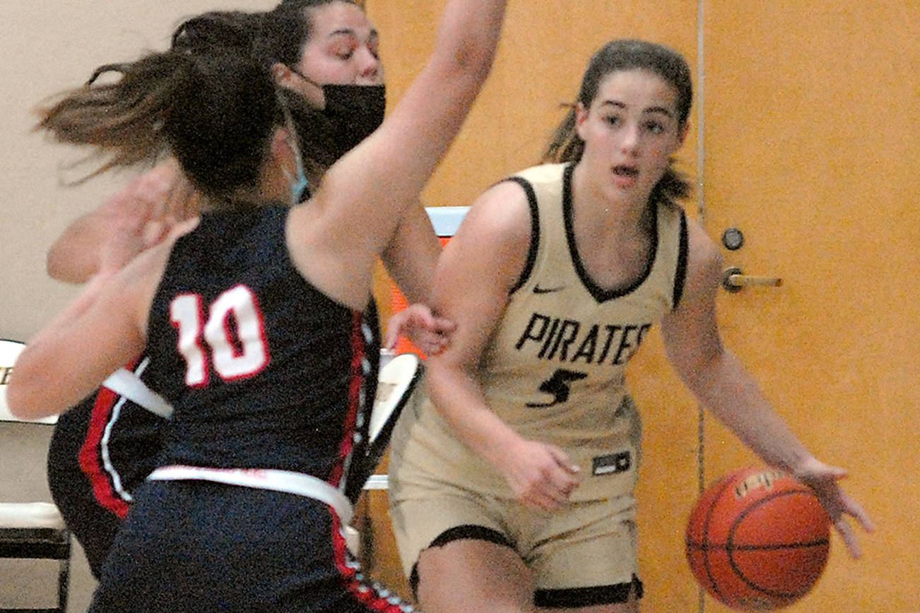 Keith Thorpe/Peninsula Daily News
Peninsula's Hope Glasser, a graduate of Sequim High School, right, fends of the defense of Bellevue's Mo Bungay, front, and Mckayla Rodriguez on Saturday in Port Angeles.