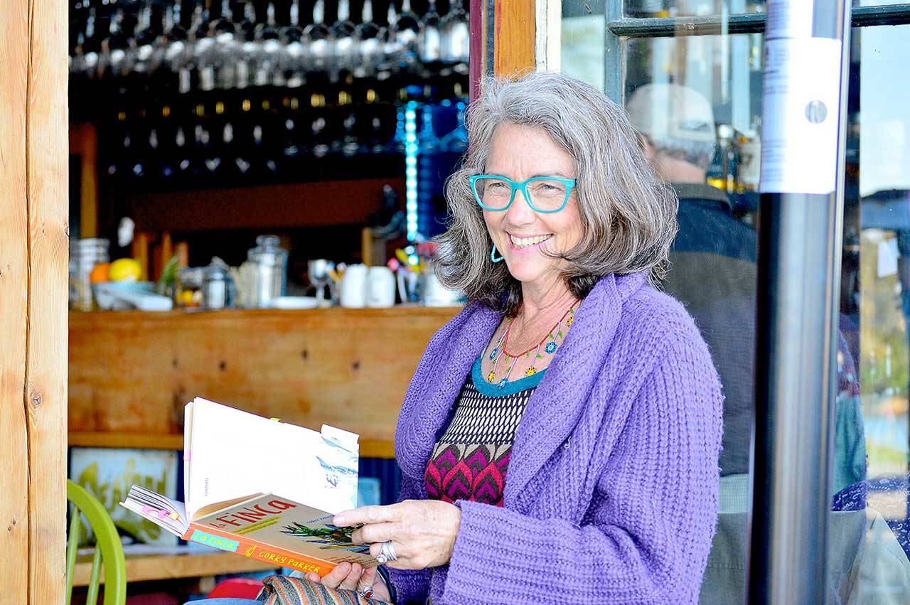 Author Corky Parker of Port Townsend gives a reading at the Ajax Cafe of her new book, “La Finca: Love, Loss and Laundry on a Tiny Puerto Rican Island.” (Diane Urbani de la Paz/Peninsula Daily News)