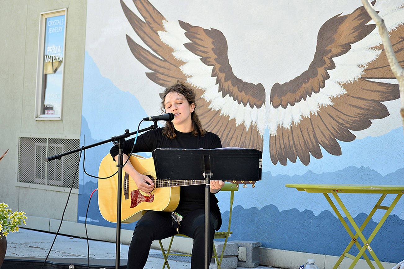 Port Townsend entertainer Phina Pipia is pictured playing a free concert on the Tyler Street Plaza last Thursday; she’s slated to return at 2 p.m. this Thursday for another Buskers on the Block performance sponsored by the Main Street Program. The hour-long gigs in downtown Port Townsend showcase local artists such as Pipia, who has just returned to public performances after a year. She plays original songs including tracks from her new album and songbook, “Outside of the Movies.” More awaits at phinapipia.com. (Diane Urbani de la Paz/Peninsula Daily News)