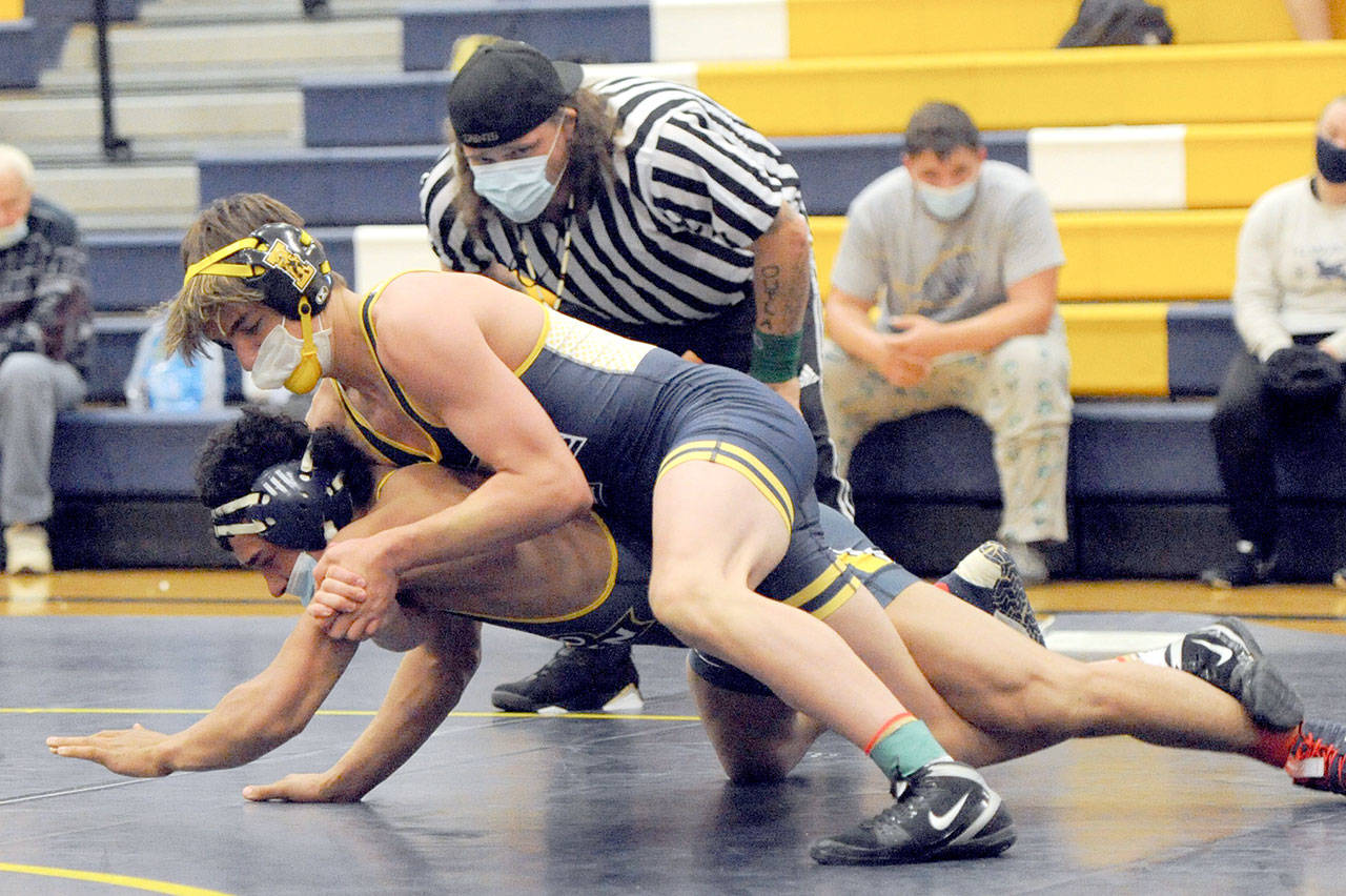 Forks Jake Weakley, top, pinned Ilwacos Keegan Kemmer in the 152-pound class Wednesday evening in Forks. Forks Mike Blair officiated the match. (Lonnie Archibald/for Peninsula Daily News)