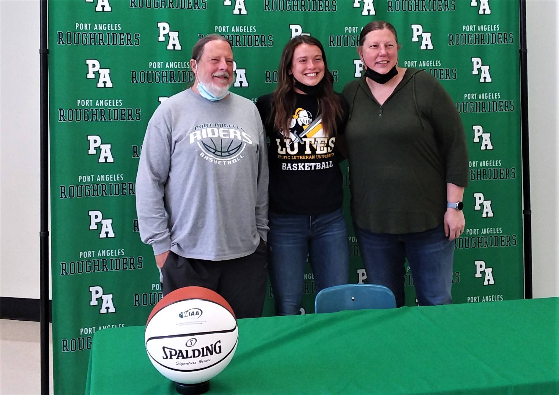 From left, Port Angeles girls basketball coach Michael Poindexter, Jaida Wood and assistant coach Jennifer Rogers at Wood's signing ceremony to play college basketball at Pacific Lutheran University. (Pierre LaBossiere/Peninsula Daily News)