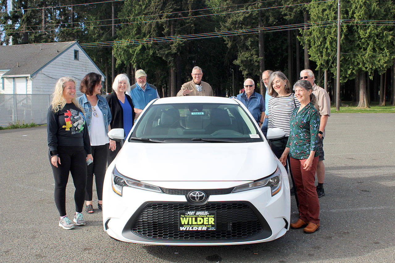 Past winners of the Great Olympic Peninsula Duck Derby grand prize gather at Swain’s General Store with Wilder Toyota owner Dan Wilder to see this year’s top prize, a 2021 Toyota Corolla, donated by Wilder. From left are Angeline Parrish, 2019 winner; Kim Skerbeck, 1995; Mary and Harry Hebert, 2002; Tom Baerman, winner along with wife Jackie, 2011; Dan Wilder; Steve Zenovic, 2018; Annette Wendell, 1992; Dan Sinnes, 1998, and Zenovic’s wife Nina. All of the past 30 winners of the car have been from Port Angeles and Sequim, except for one.