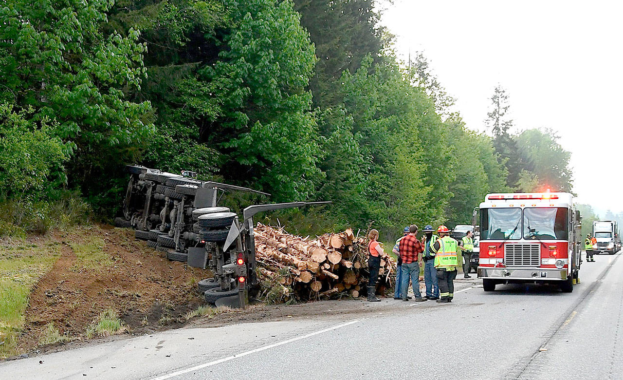 No one was injured when a log truck spilled its load after attempting to miss a car that turned in front of it. (Clallam County Fire District 2)
