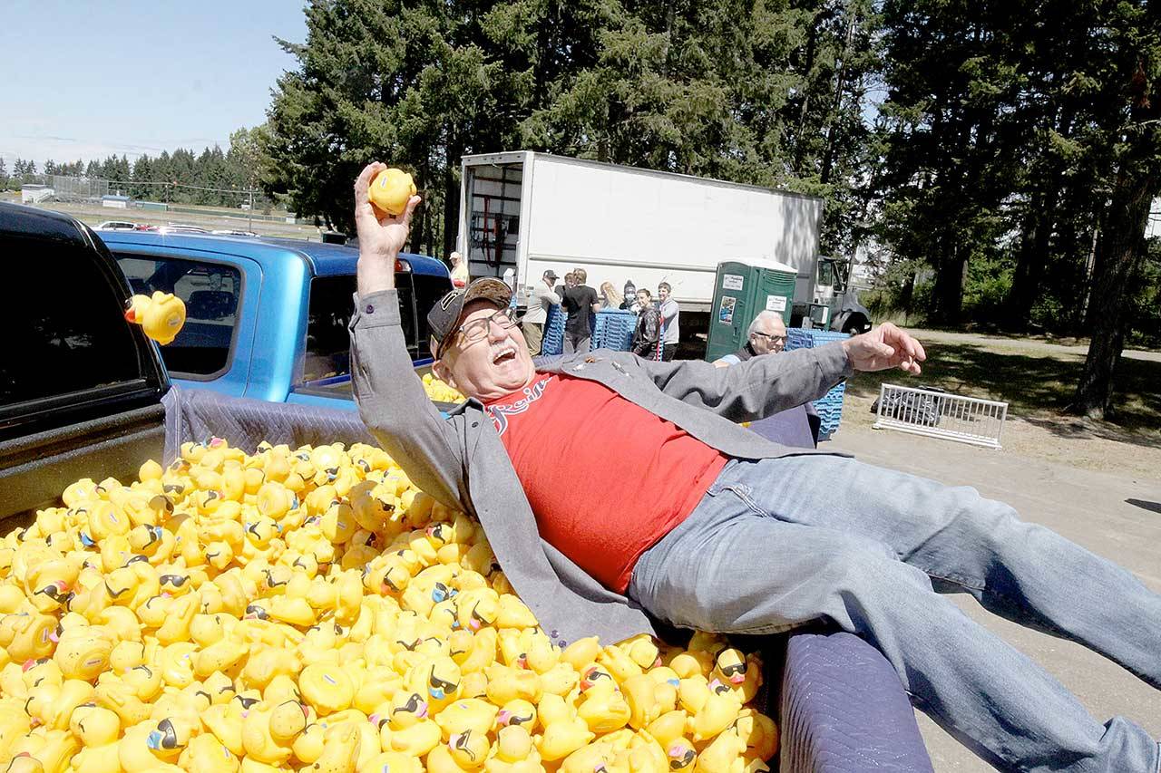 Ron Allen, CEO of the Jamestown S’Klallam Tribe, has fun grabbing one of the 40 winning ducks for the Duck Derby on Sunday at Lincoln Park in Port Angeles. The tribe is one of the major sponsors of the event. (Dave Logan/for Peninsula Daily News)