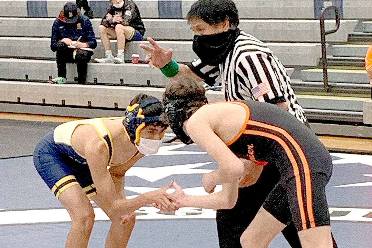 Photo courtesy of Forks wrestling
Jesus Garcia-Dominquez of Forks, left, wrestles against a Rainier opponent at the Sgt. Justin Norton Memorial Wrestling Tournament in Rainier on Saturday. Garcia-Dominguez won his 113-pound weight class and the Spartans won the meet as a team.