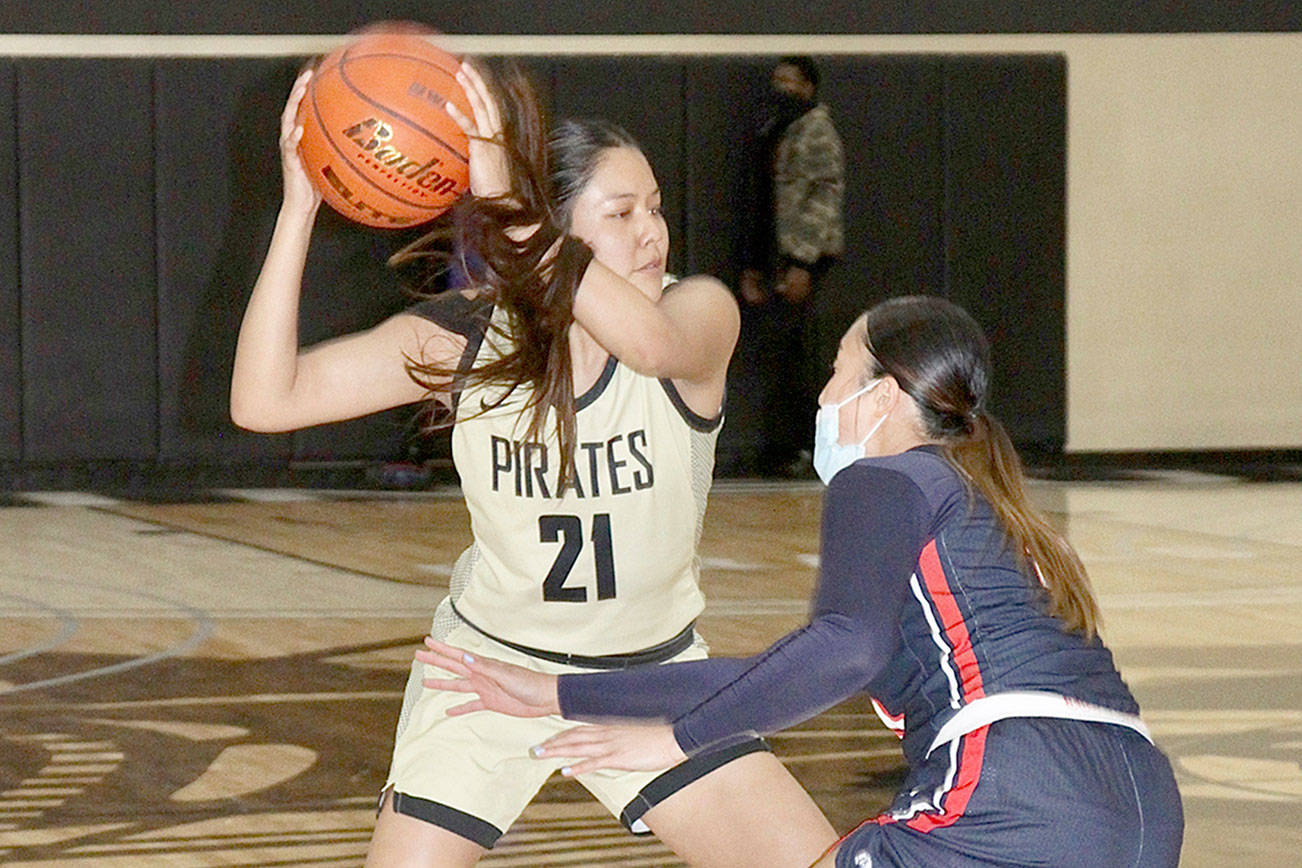 Tasiah Little of the PC Women’s basketball is guarded by Bellevue Bulldog Keani Midel Monday at the PC gym. PC lost by a “hair” to the Bulldogs. dlogan