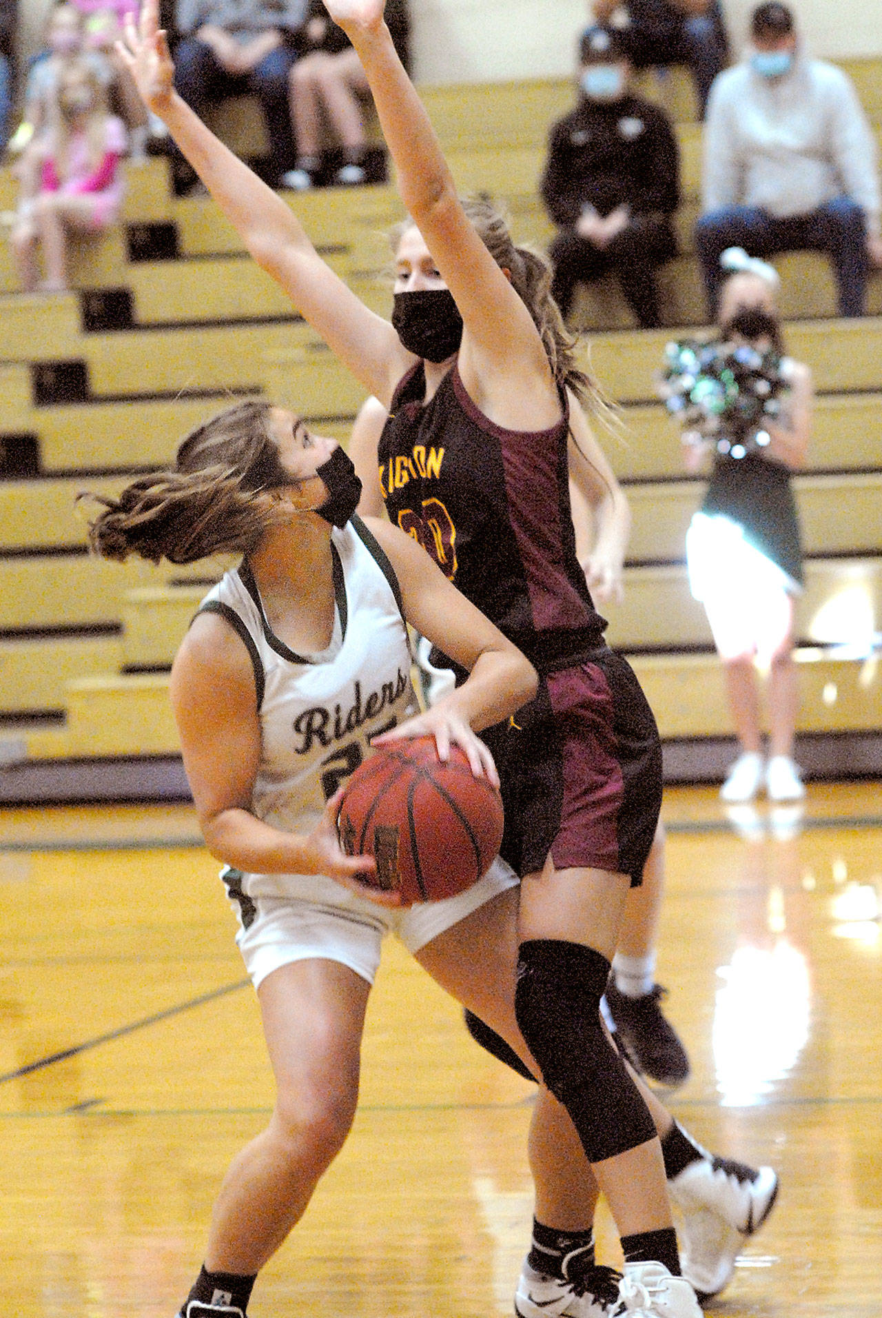 Keith Thorpe/Peninsula Daily News Port Angeles’ Eve Burke, left, looks for a shot around Kingston’s Ellee Brockman on Friday night at Port Angeles High School.
