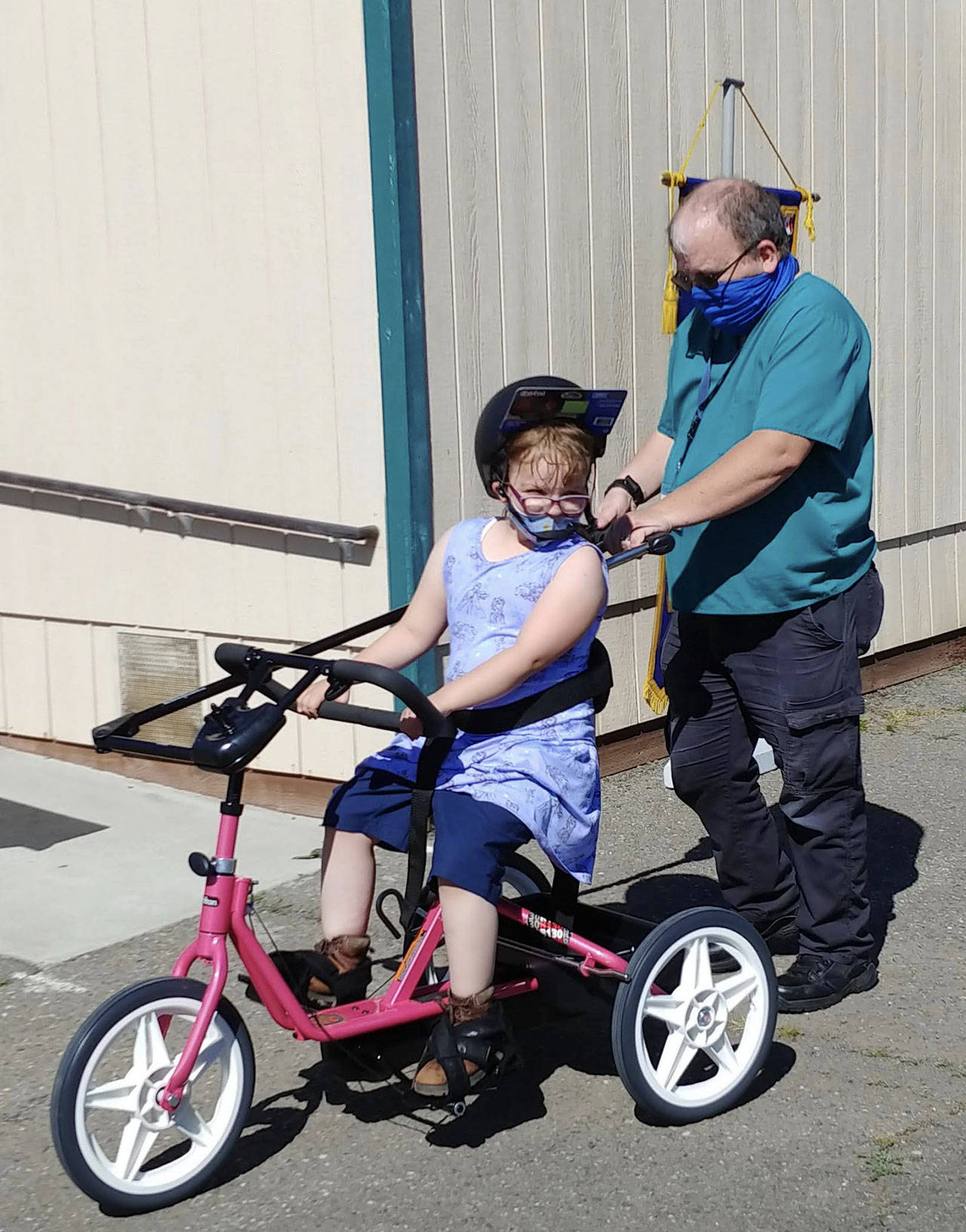 A Sequim student enjoys a ride on a newly donated adaptive bicycle, donated by Rotary Club of Sequim.