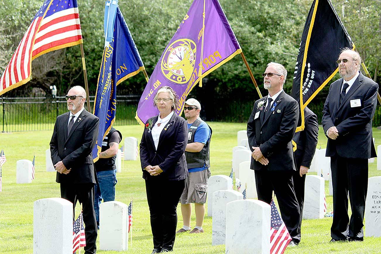 Elks Lodge 317 members, from left, Mark Banks, trustee; Shirley Beck, leading knight; James Aman, loyal knight; and Greg Carroll, chaplain, stand in front of the Marvin Shields Post 26 American Legion color guard during a joint Memorial Day ceremony Monday at the Fort Worden Cemetery. Elks trustee David Crozier carried the Elks flag as part of the day’s color guard. (Zach Jablonski/Peninsula Daily News)
