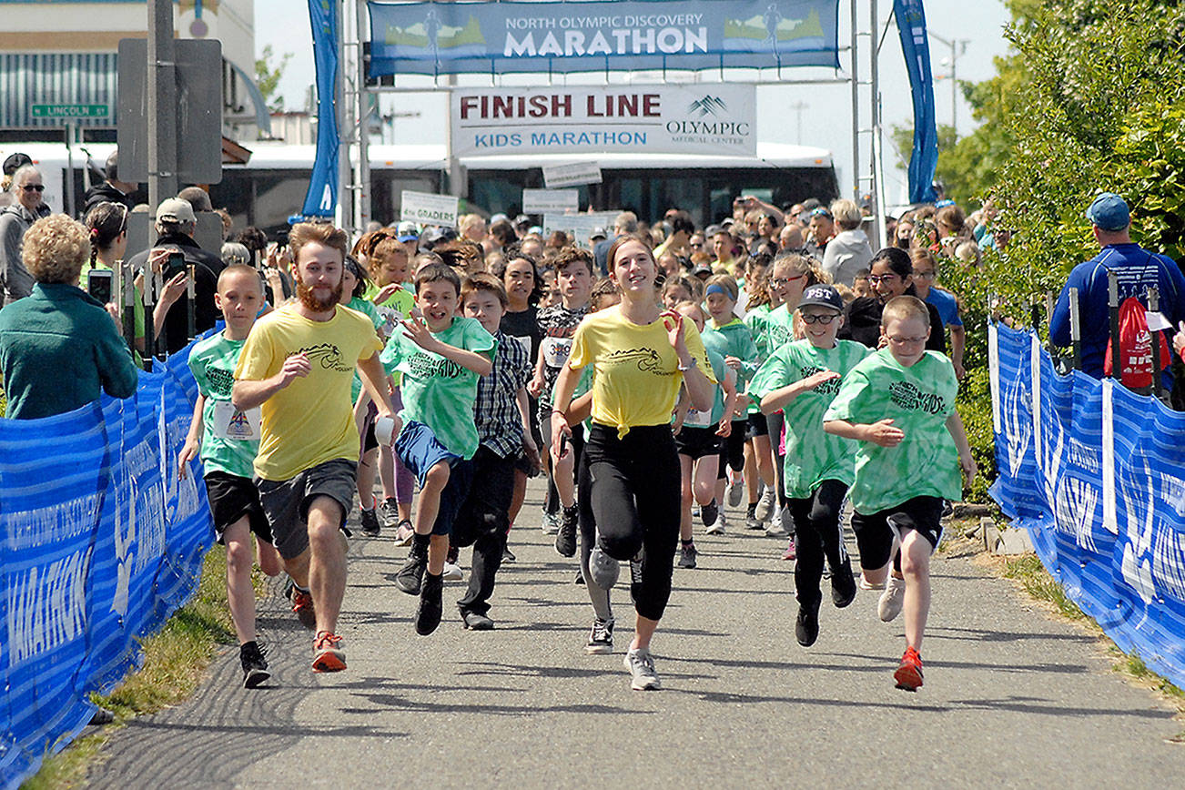 Youngsters accompanied by a pair of pace runners take off down the Waterfront Trail portion of the Olympic Discovery Trail from Port Angeles City Pier during the 2019 North Olympic Discovery Marathon Kid's Marathon. (Keith Thorpe/Peninsula Daily News)