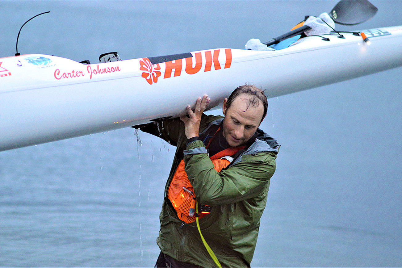 "I got it," said Seventy48 winner Carter Johnson as he carried his kayak onto shore just before 5 a.m. Saturday. Diane Urbani de la Paz/Peninsula Daily News