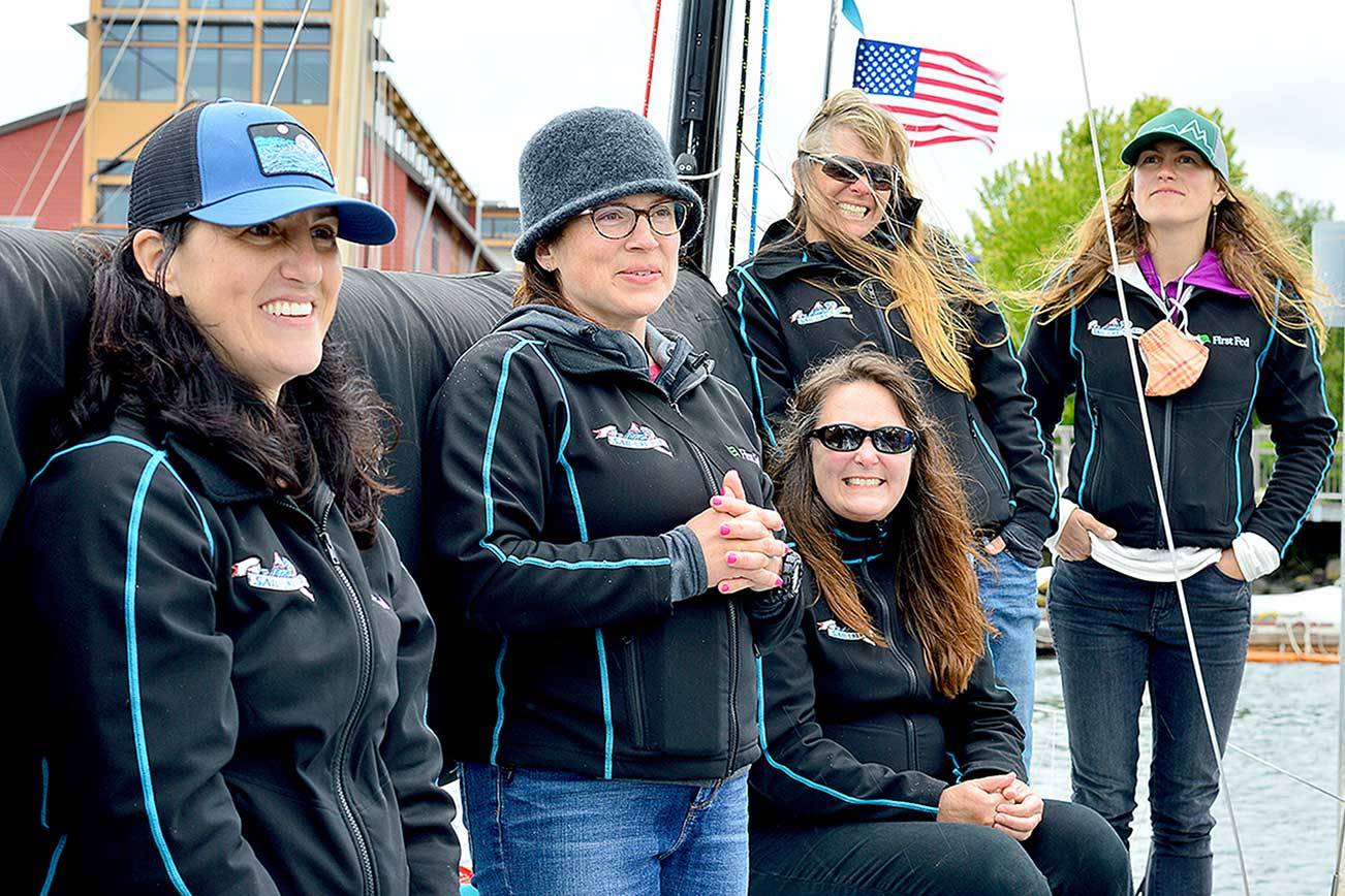 Team Sail Like a Girl, listening to a sendoff song composed especially for them, includes, from left, Jeanne Goussev, Christa Bassett Ross, Lisa Cole, Laurie Anna Kaplan and Elisha Van Luven. The team will take off this morning on the new WA360 race from Port Townsend. (Diane Urbani de la Paz/Peninsula Daily News)