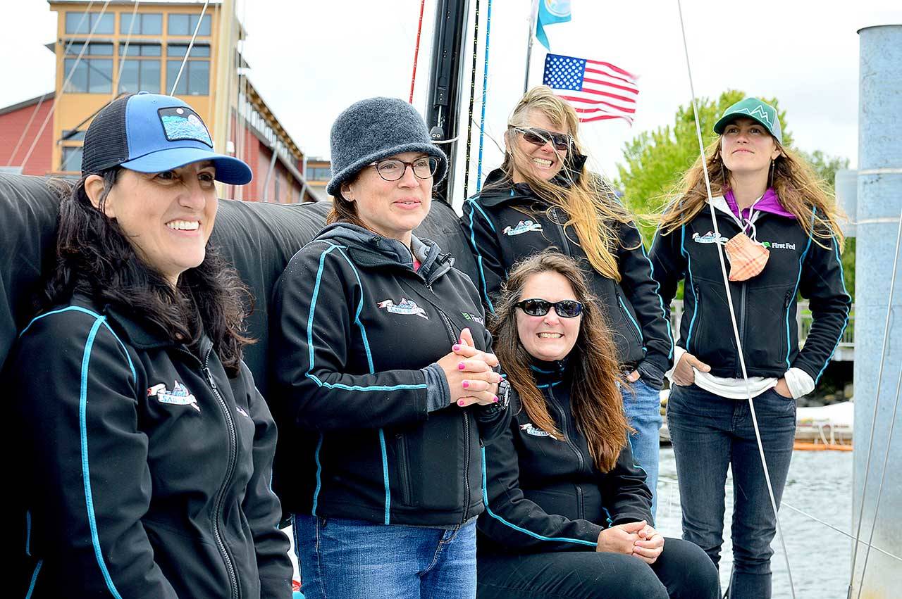 Team Sail Like a Girl, listening to a sendoff song composed especially for them, includes, from left, Jeanne Goussev, Christa Bassett Ross, Lisa Cole, Laurie Anna Kaplan and Elisha Van Luven. The team will take off this morning on the new WA360 race from Port Townsend. (Diane Urbani de la Paz/Peninsula Daily News)
