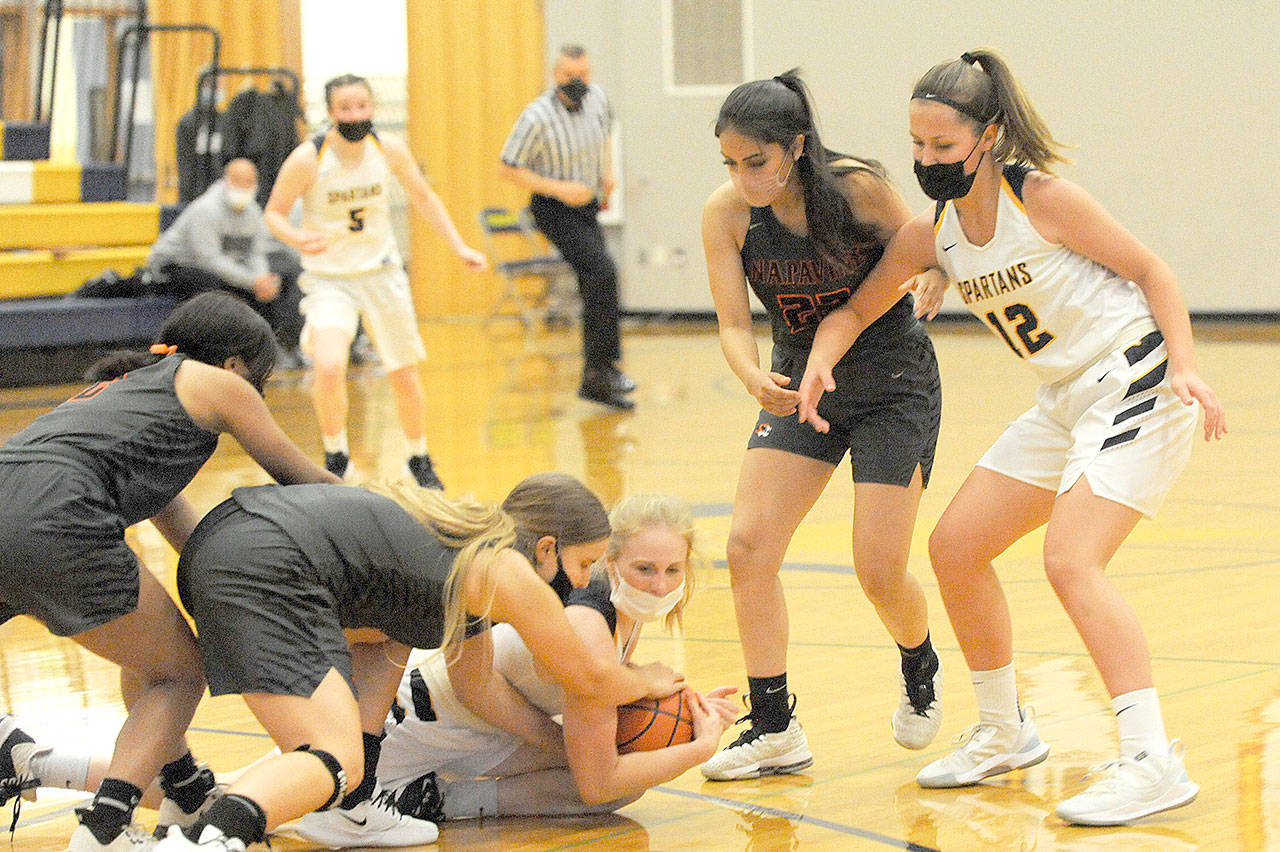 Lonnie Archibald/for Peninsula Daily News Hustling for the ball Monday in Forks are Napavine’s Rae Sisson (left) and Forks’ Kadie Wood. Looking on from the right are Napavine’s Natalya Marcial and Forks’ Kray Horton (12). Napavine got by the Spartans 54-52 to end Forks’ season.