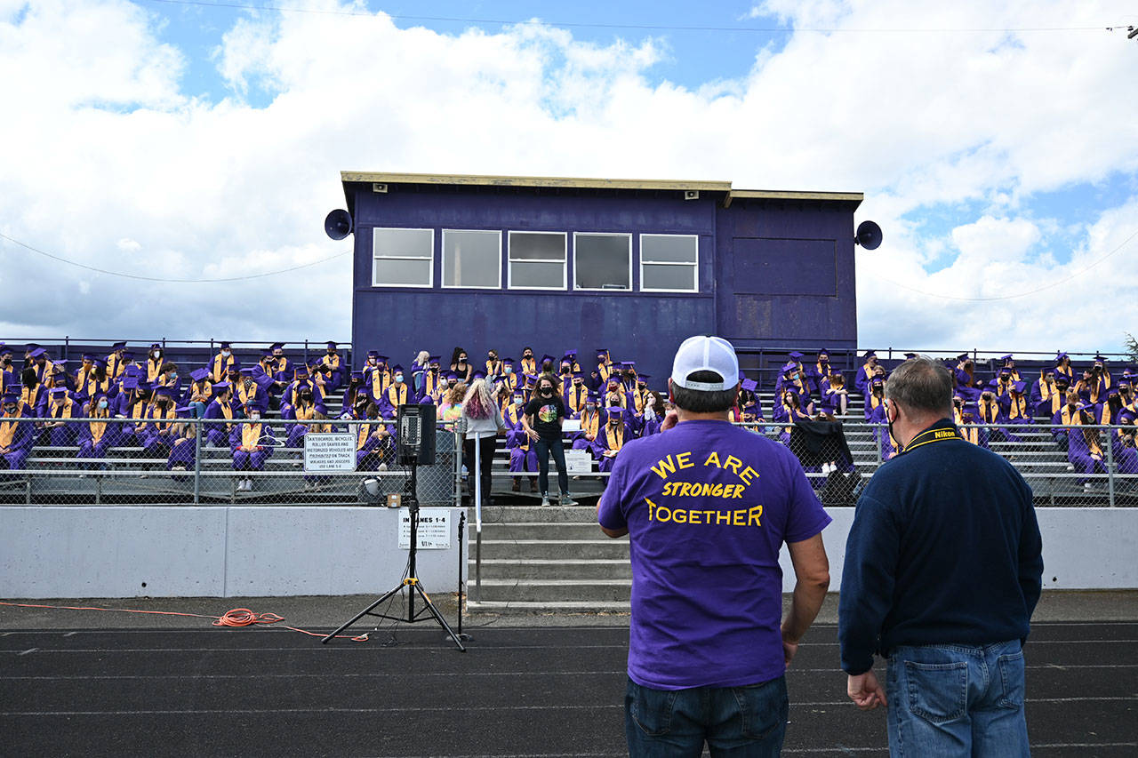 Sequim High School principal Shawn Langston (foreground, left) and photography teacher Jim Heintz look on at an SHS graduation rehearsal on Jan 9. An estimated 187 seniors will graduate at the school’s commencement ceremony on Friday. (Michael Dashiell/Olympic Peninsula News Group)