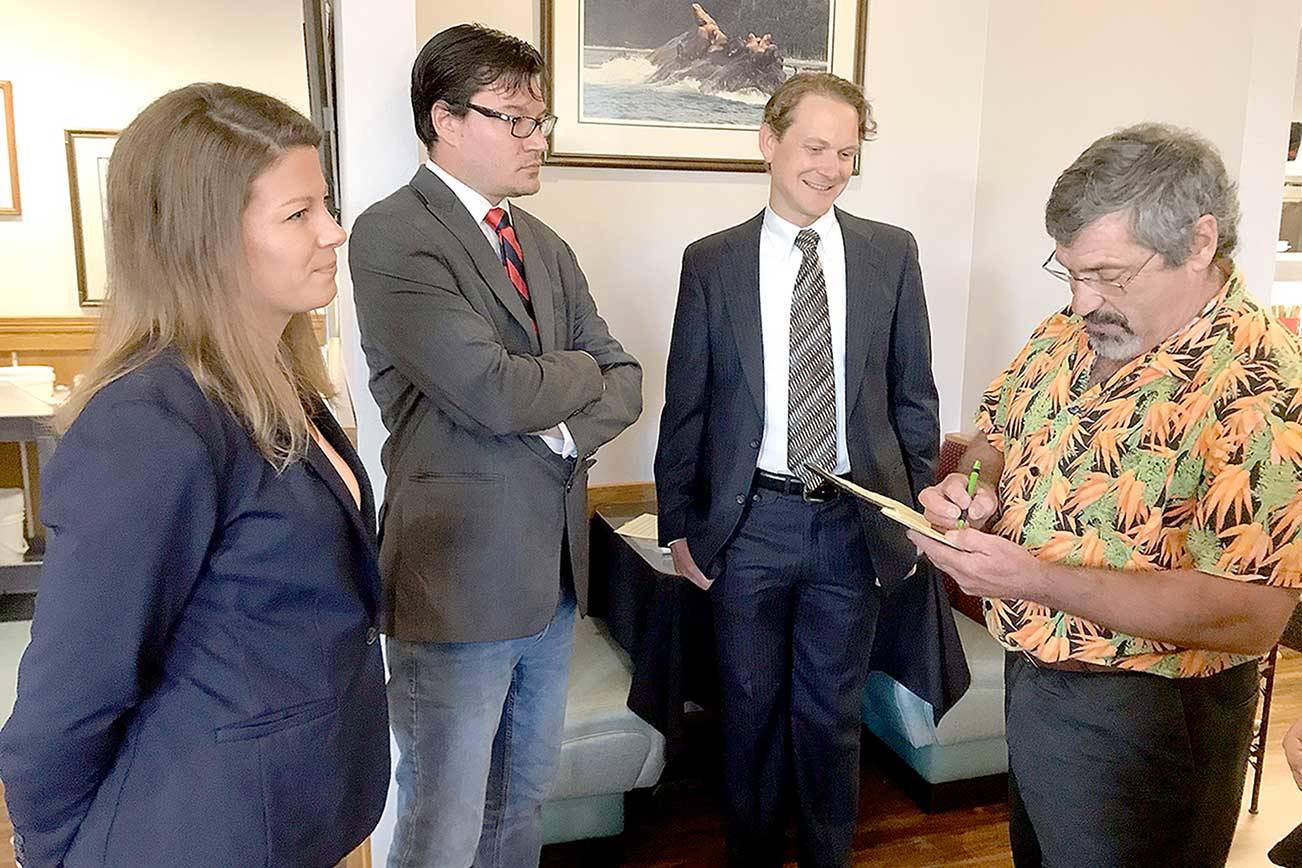 Left to right, Port Angeles City Council candidates Jena Stamper, Jason Thompson and Lindsey Schromen-Wawrin receive election forum format information from moderator Andrew May. (Paul Gottlieb/Peninsula Daily News)