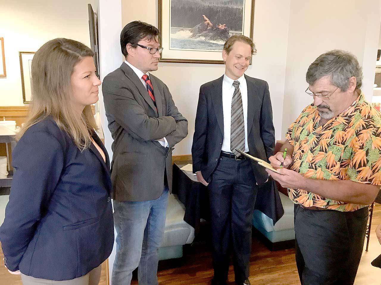 Left to right, Port Angeles City Council candidates Jena Stamper, Jason Thompson and Lindsey Schromen-Wawrin receive election forum format information from moderator Andrew May. (Paul Gottlieb/Peninsula Daily News)