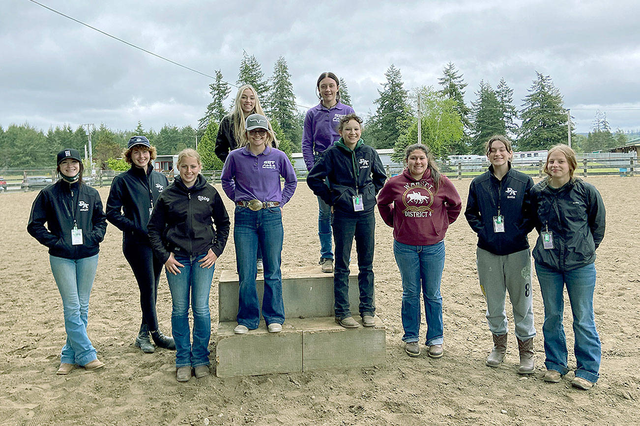 Sequim and Port Angeles high school equestrian teams take a break at the Washington High School Equestrian Team District 4's third and final meet in Elma before state finals. They are bottom row, from left, Haley Bishop (PA), Katie Marchant (PA), Libby Swanberg (S), Keri Tucker (S), Sydney Hutton (PA), Abby Garcia (S), Sara Holland (PA) and Amelia Kinney (PA); top row, from left, Susannah Sharp (S) and Rainey Bronsink (S). (Photo courtesy of Katie Newton)